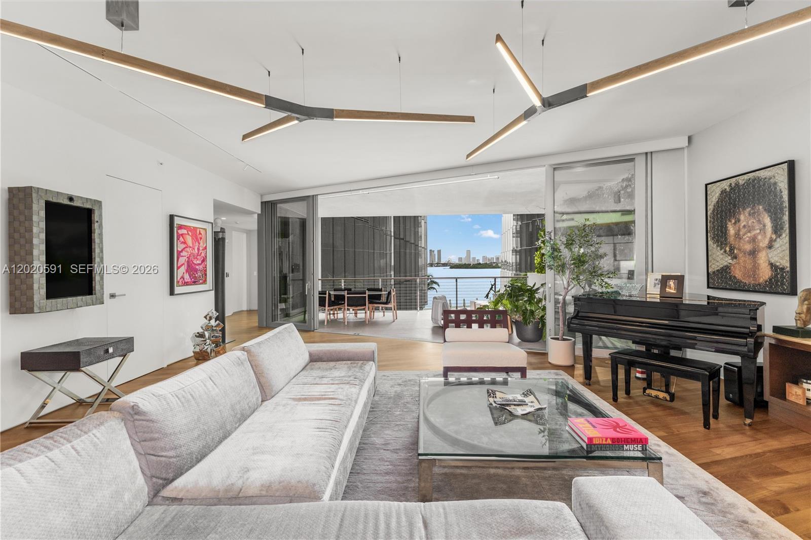Rarely available & meticulously curated, this stunning Unit E residence at Monad Terrace offers an unparalleled luxury lifestyle in South Beach. Spanning 2,282 SF of sophisticated interior living space, this turnkey 2BR+custom office, 2.5BA home features over $250k in premium bespoke upgrades. Arrive via private elevator foyer into an expansive, light-filled layout framed by floor-to-ceiling windows, custom designer lighting, and remote-controlled motorized blinds. The interior seamlessly flows to 1476 SF of massive private balconies boasting panoramic views of Biscayne Bay & the Miami skyline, effectively doubling your entertaining space. Designed by Pritzker Prize-winning architect Jean Nouvel, Monad Terrace is a modern masterpiece centered around a climbing-gardened lagoon. Elite Building Amenities Include: Bayside sun deck with a 116-foot swimming pool & hot tub, poolside juice bar, 24-hour concierge, valet, elite security, and a state-of-the-art fitness center & wellness spa. Perfectly positioned at 1300 Monad Terrace, you are steps from premier dining, shopping, and nightlife.