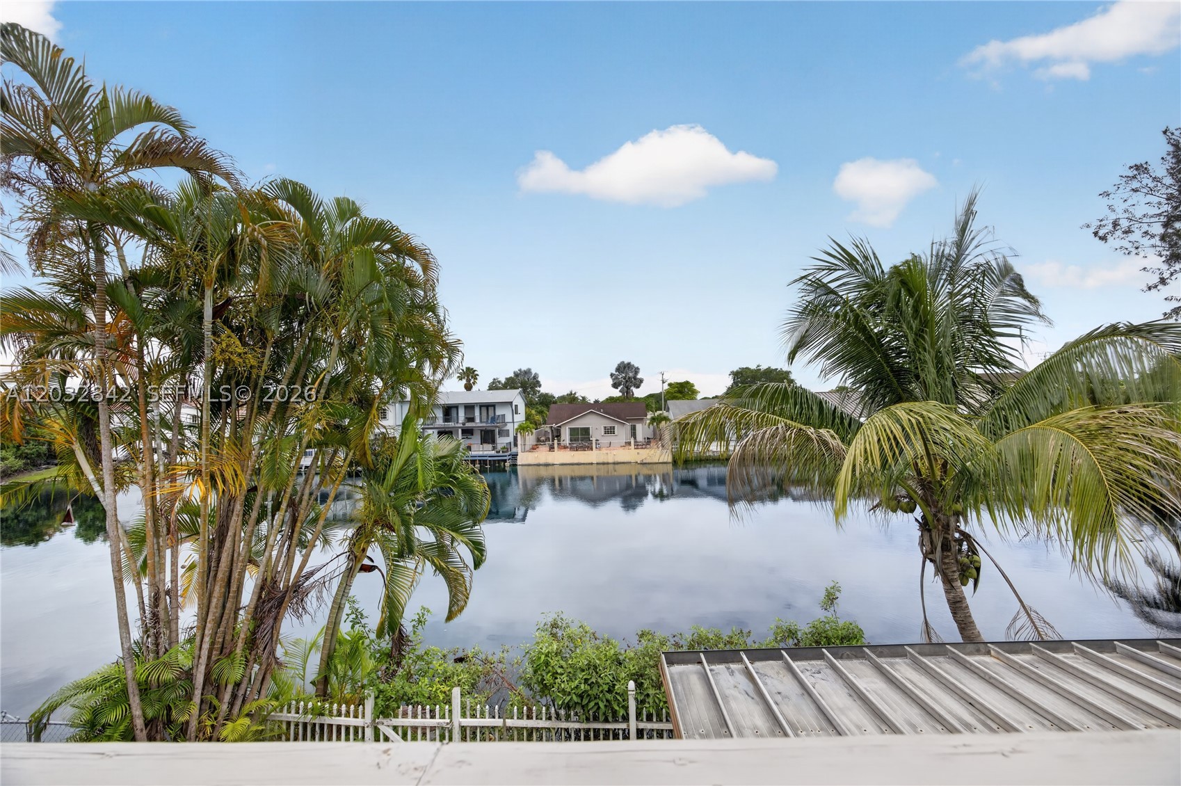 Rare oppotunity in small community of Hidden Lake in Kendall.  Spacious 2 story townhouse  in East Kendall with one car garage on cul-de-sac, Move in condition
New roof installed 2023.  Accordion shutters.  1 bedroom with full bathroom downstairs. 3/2 upstairs. All rooms upstairs open to rear balcony with water views.  Wood laminate floors upstairs and all tiled living areas downstairs.
Covered patio with extended wood deck overlaking lake. Excellent location near Baptist with access to major roads and highways. Low HOA fee covers  lawn and ecological care of the Lake.
