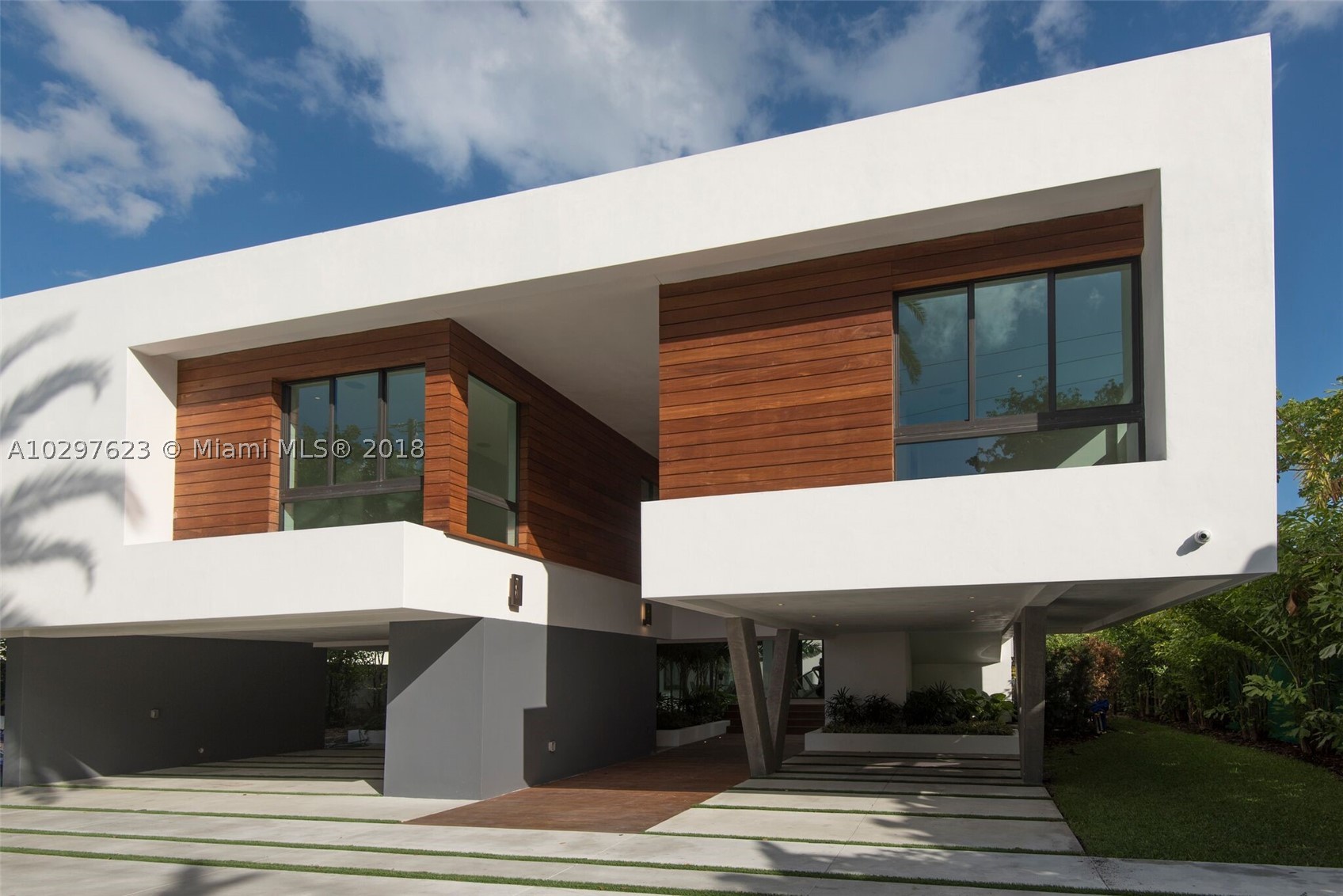 Brand New Modern Masterpiece.  Incredible 3 level oasis on prestigious Pine Tree Drive with 70 feet on the water with private dock and poolside cabana. Filled with natural light and walls of glass, it offers 6 bedrooms, 6 bathrooms and 2 half bathrooms.  Open floor plan, unparalleled quality and finishes, maids quarters, magnificent water views from every room. Elevator opens  to a beautiful and rare 5,000 sq.ft. rooftop sundeck.  Completed in 2016.
