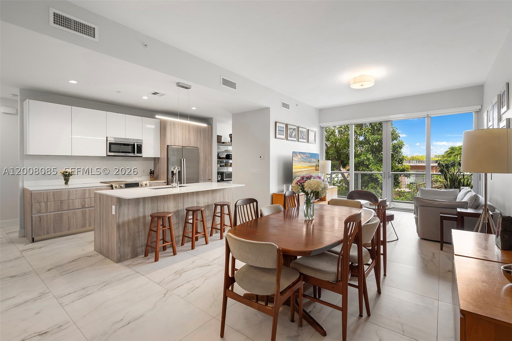 A rare opportunity to own within one of The Roads’ most design-forward boutique buildings, just moments from Brickell yet tucked away in a quiet residential setting. Residence 208 at Eleven in the Roads offers the perfect balance of modern luxury, privacy, and walkable urban living. This spacious 3bd/3ba home features soaring 11-foot ceilings, expansive floor-to-ceiling glass, and an open-concept layout filled with natural light. Thoughtfully designed interiors include Italkraft cabinetry, Bosch appliances, quartz countertops, custom closets, double window treatments, and refined contemporary finishes throughout. Unlike a traditional high-rise experience, Eleven in the Roads offers an intimate boutique atmosphere with only 24 residences, creating a more private and residential feel while remaining minutes from Brickell, Coconut Grove, Key Biscayne, and Downtown Miami. Ideal for buyers seeking a turnkey, lock-and-leave lifestyle without sacrificing space, design, or convenience, this residence delivers elevated Miami living in one of the city’s most connected neighborhoods.