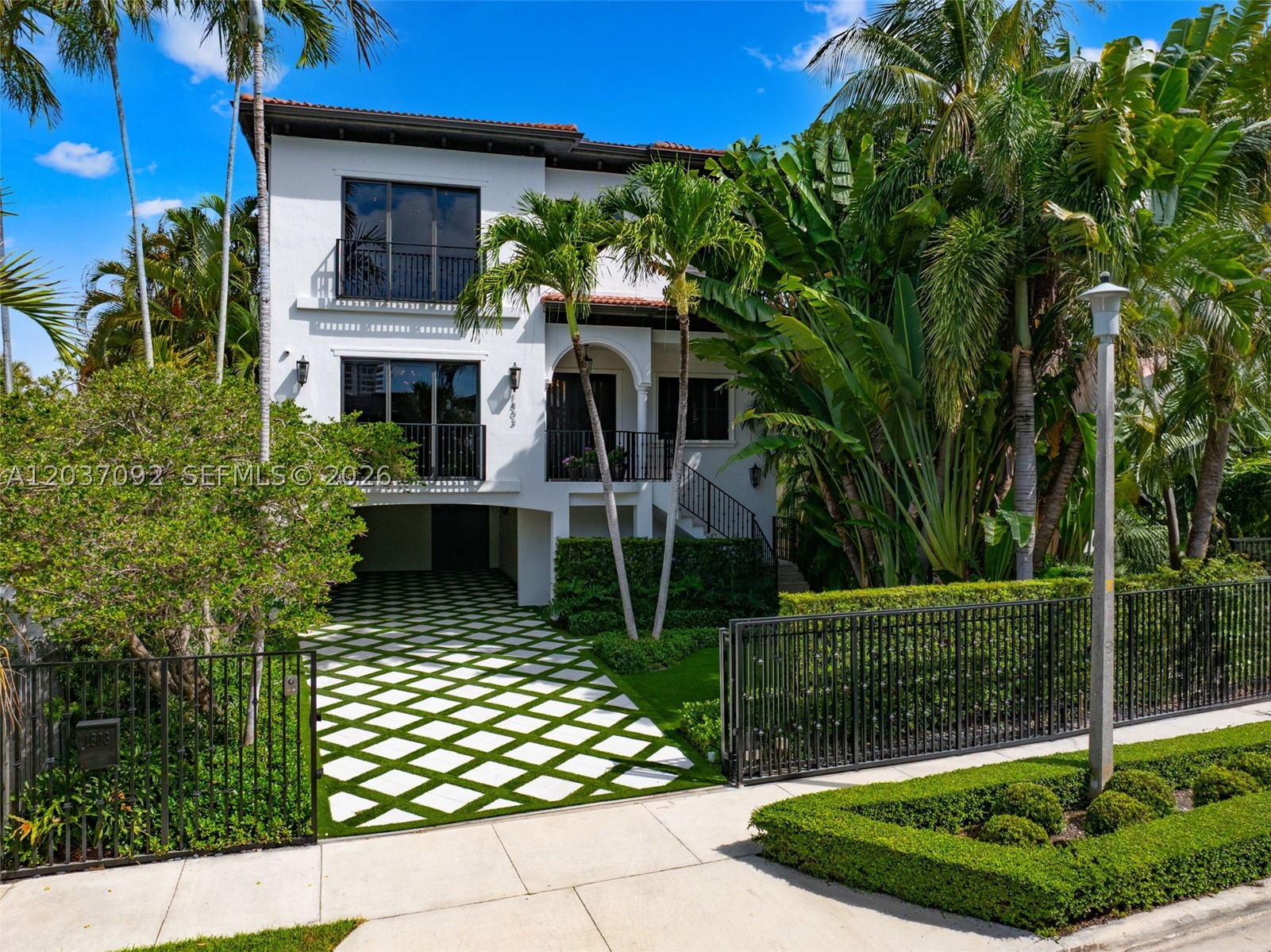 Completely renovated in 2025, this gated three-story residence in Coconut Grove offers refined living with custom millwork throughout, a private elevator, and curated designer finishes. The main living level features expansive open living and dining spaces anchored by a fully renovated chef’s kitchen with quartzite countertops, designed for both everyday living and entertaining, along with a custom mudroom for added functionality. The primary suite is a private retreat with dual custom walk-in closets and a floor-to-ceiling marble bathroom with dual sinks, a built-in vanity, and oversized LED mirrors. Finished with Kelly Wearstler fabric paneling and drapery, the suite exudes a layered designer aesthetic, while a custom coffee bar with a built-in beverage refrigerator just outside adds convenience. A secondary bedroom suite has been fully renovated with custom millwork, tufted wall paneling, a built-in bench, and designer wallpaper. Thoughtfully designed for modern living, the home also features two laundry rooms and a covered carport. The outdoor spaces are thoughtfully designed for entertaining, featuring generous covered lounge and dining areas overlooking the pool and private landscaped backyard. Tucked within the grounds, a detached 1-bedroom, 1-bath guest house with its own kitchen and dining area provides a private, self-contained space for guests, family, or staff.