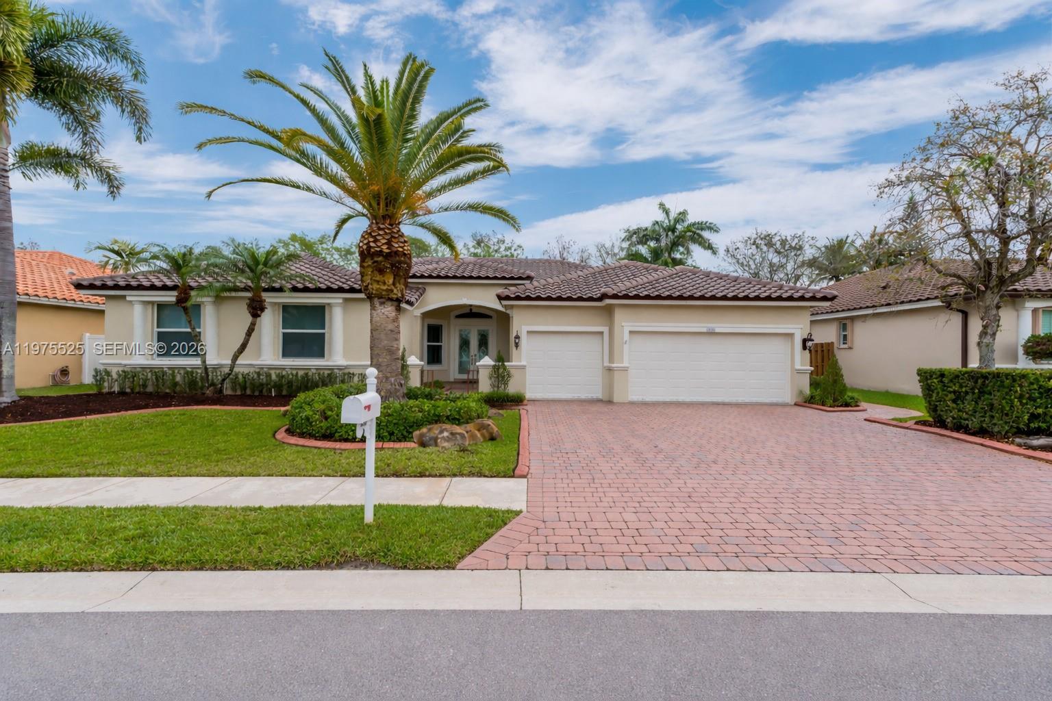 Beautifully maintained 5-bedroom, 3-bathroom home featuring a desirable split bedroom floor plan that offers both privacy and functionality. This home has been thoughtfully upgraded with a brand new roof, hurricane impact windows, and freshly painted interior and exterior. Step inside to soaring ceilings and spacious living areas, including a generously sized dining room and multiple living spaces perfect for entertaining and everyday living. The chef’s kitchen features granite countertops, top-of-the-line appliances, a well-sized pantry, and an open layout overlooking the main living area. The primary suite and all bedrooms feature warm wood flooring, while plantation shutters throughout the home add a timeless and elegant touch. The guest bathrooms and cabana bathroom have been tastefully updated. Step outside through French doors to a beautifully designed backyard featuring a brand new saltwater pool surrounded by elegant travertine pavers and a spacious yard, creating the perfect setting for relaxing or entertaining.