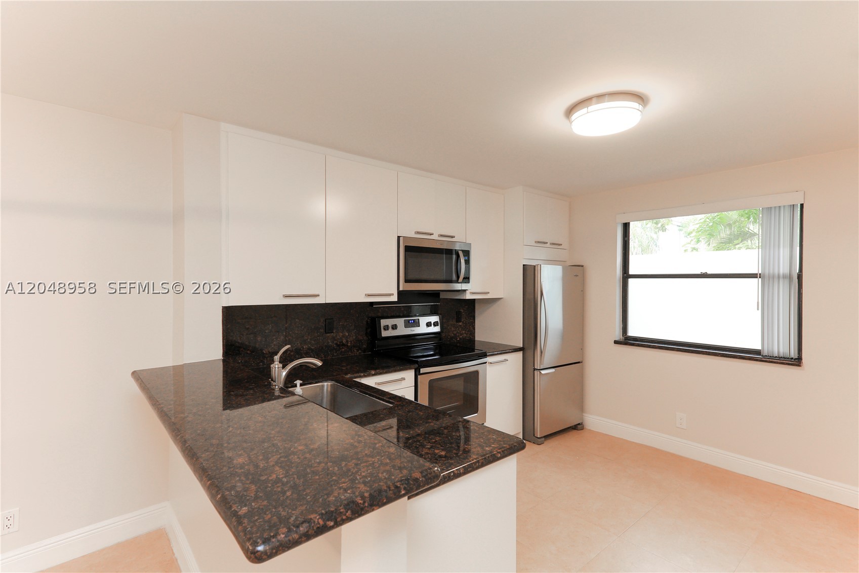 Luxurious living awaits at Grand Marquis Condo in Plantation! This modern first-floor 2 bed/2 bath unit features a remodeled kitchen with granite countertops and newer stainless steel appliances. Enjoy sleek porcelain tile flooring throughout, flush ceilings, and the convenience of an in-unit washer/dryer. Both bathrooms have been tastefully remodeled, and built-in closets provide ample storage. Hurricane impact windows/doors ensure security.Experience resort-style amenities: swimming pool, clubhouse with a modern gym and game room, and an updated tennis court with lights. The gated complex offers enhanced safety amidst lush green spaces and serene fountains. Available to rent starting Aug 15th, 2026. Don't miss out on the epitome of comfort and style in this meticulously maintained condo.