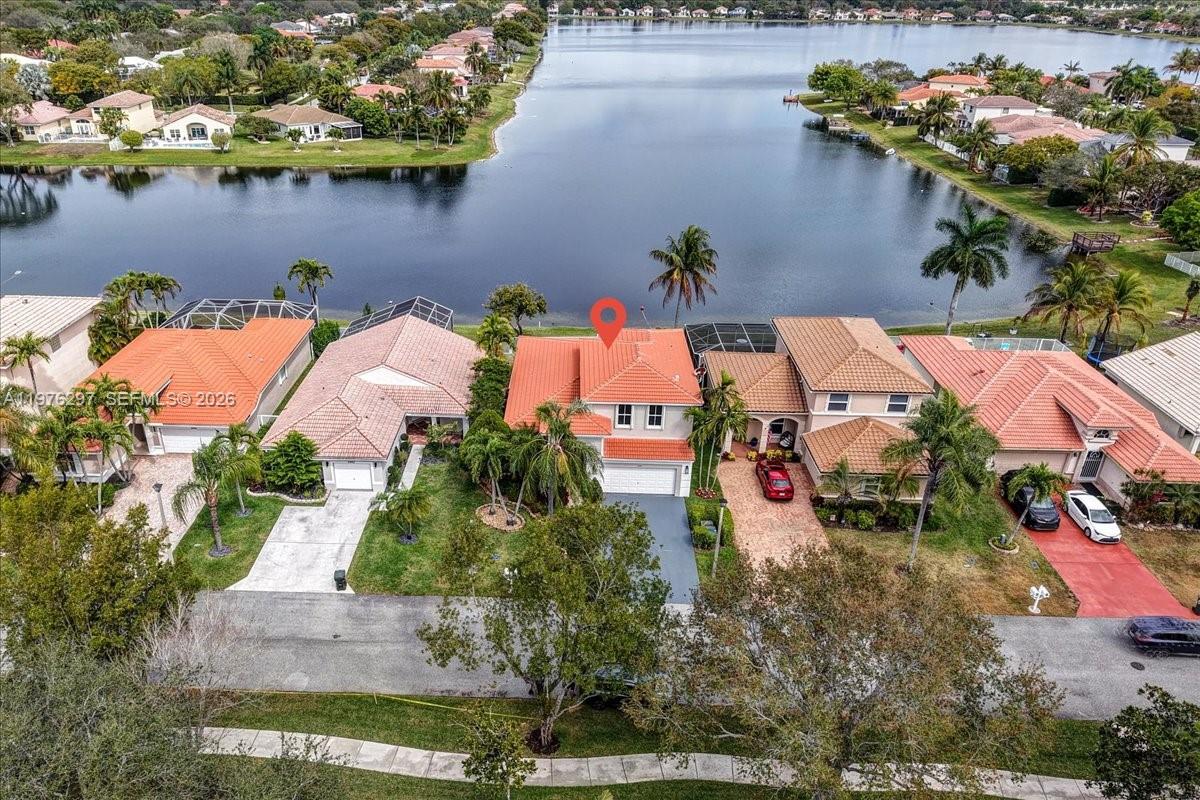 Fully Renovated 2-Story Lakefront Home! This stunning and spacious 4 bedroom 2.5 bathroom home is located in the highly desirable Coco Lakes community and offers peaceful lakefront living in a prime location. The thoughtfully designed and flexible floor plan includes the primary bedroom and bathroom suite on the 1st floor offering a private retreat with dual sinks, soaking tub, walk-in shower, and ample closet space.. The updated kitchen features brand new matte black stainless steel appliances, generous cabinetry, and ample counter space, seamlessly connecting to the main living areas for everyday living and entertaining. Throughout the home you’ll find new flooring, beautifully renovated bathrooms with modern tile and fixtures, and fresh interior finishes creating a clean, move-in ready feel. Step outside to enjoy your relaxing patio and pool overlooking a serene 55-acre lake, providing a relaxing setting for outdoor dining, entertaining, or quiet evenings at home. Additional features include a 2-car garage, fairly new (approx 5 years old) barrel tile roof and AC system. Ideally located within walking distance to Sabal Pines Park and Butterfly World, with nearby parks, schools, shopping, and dining, this home offers a wonderful opportunity to enjoy the comfort and lifestyle of the Coco Lakes community.
