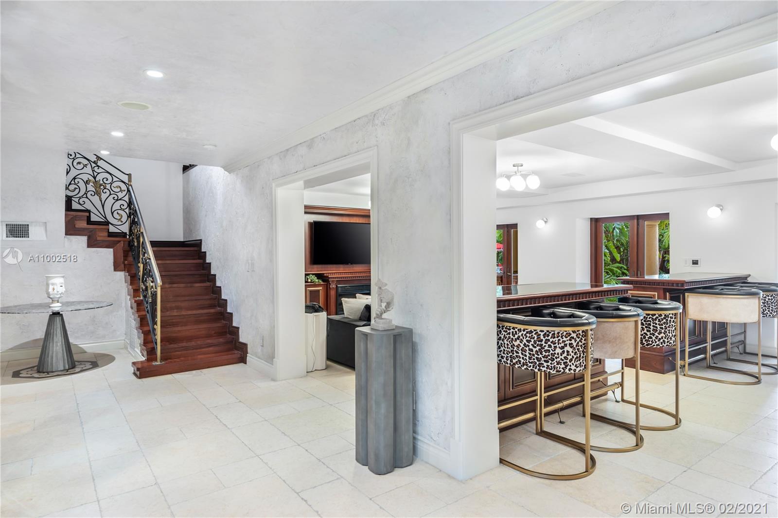 One of a kind estate on a 39,000 sq ft lot. Beautiful open courtyard. A recently renovated grand estate offering exquisite mahogany wood details, 25' fireplace, game room, 2 separate private guest houses, staff room, office, gourmet kitchen w/island, impressive large master suite, terraces, loggias, fountains, resort style pool, gazebo, summer kitchen, and outstanding grounds. 10 bedrooms, 10 bathrooms, 3 half baths. A total of 4 kitchens throughout the property. Excellent dockage for large 100ft+ yacht plus additional boat lift and jet ski lift. Equipped with natural gas generator to power the complete home. Luxury abounds throughout this extraordinary waterfront estate. Impressive views to the historical founainebleau hotel. No neighbors to your left side.