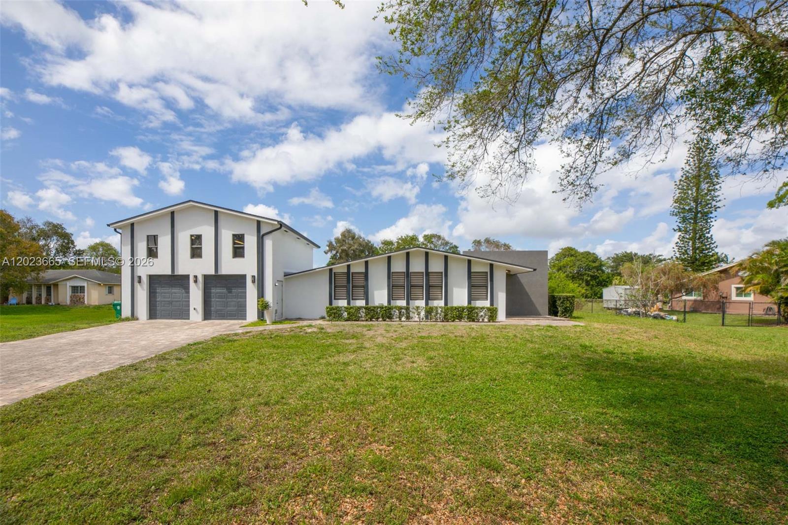 Exceptional Southwest Ranches estate on nearly one acre with no HOA, offering the perfect blend of luxury, privacy, and functionality. Completely renovated with no expense spared, this stunning residence showcases high-end finishes throughout,including elegant flooring,designer lighting,custom details, and an open-concept layout filled with natural light. The beautifully updated chef's kitchen features premium cabinetry, upgraded countertops, stainless steel appliances, and stylish finishes ideal for both everyday living and entertaining. Luxuriously renovated bathrooms offer spa-inspired comfort, while the primary suite provides a private retreat. 3 bedrooms, 2 bathrooms, and a large executive office that can easily serve as a fourth bedroom, gym, media room, or workspace, the home offers exceptional flexibility. One of the property's standout features is the oversized garage and workshop space, perfect for multiple vehicles,trucks,recreational toys,equipment,storage, or a home-based business. The expansive driveway and nearly one-acre lot provide ample room for RVs,boats, trailers, and additional parking or an addition. Located South Florida's most sought-after acreage communities, this rare property combines country-style living with convenient access to major highways,shopping,dining, parks, and top-rated schools. A unique opportunity to own a fully renovated Southwest Ranches home offering luxury finishes,usable land, and the freedom that only acreage living can provide.