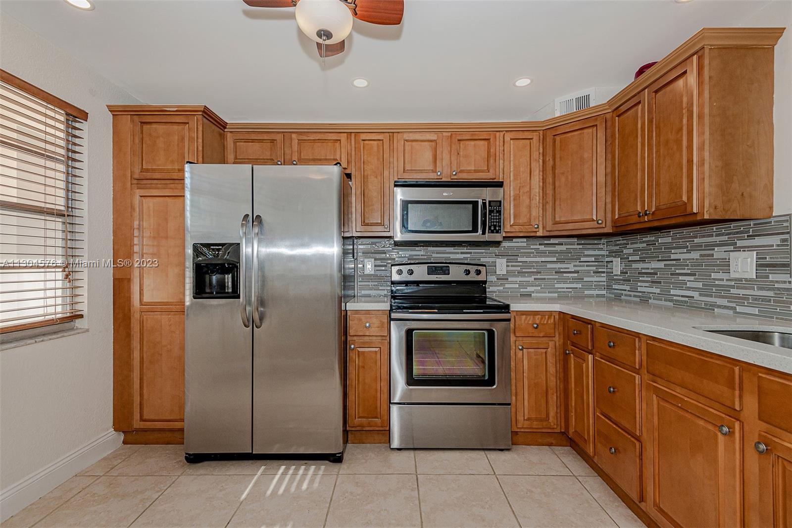 If you have been looking in Wynmoor Village, this is the one, best parking spot in the building, steps from your new condo. Check out this beautifully updated 2 bedroom/2-bathroom condo overlooking the golf course.  Located in an active 55+ resort style community, feel at peace in this 24/7 manned gated security.   The kitchen has quartz countertops with stainless steel appliances.  Both bathrooms have granite countertops.  Beautiful vinyl destressed wood looking flooring throughout the dining room, living room and bedrooms.  Large walk-in closet in the master.   Fantastic location to parking space, laundry, and storage room.  Many amenities include community bus service, movie theater, exercise facilities, tennis, golf, billiards, wood working and art studios and more.