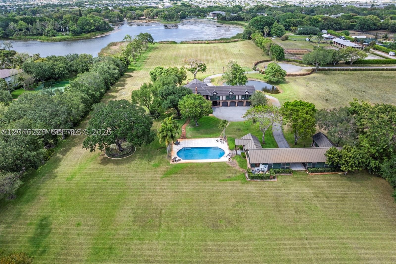 An extraordinary opportunity to acquire a spectacular 10-acre waterfront estate in the prestigious, equestrian-friendly enclave of Horseshoe Acres, one of Central Boca Raton's most exclusive communities. Surrounded by magnificent luxury estates, this exceptional property offers unparalleled privacy, expansive grounds, and serene lakefront views, all while being just minutes from Boca Raton's top-rated schools, championship golf courses, fine dining, world-class shopping, and premier lifestyle amenities. HOA may vary on size of property.

The estate features an existing 5-bedroom, 5 full and 1 half-bath main residence, a separate guest house, a 4-stall barn with storage, and a resort-style pool overlooking a private lake. Whether enjoyed as-is or reimagined into an extraordinary custom compound, the possibilities are truly limitless. Create an unrivaled private sanctuary, an equestrian estate, or a multi-structure legacy property on one of the area's most significant land offerings.

Properties of this size, caliber, and location rarely come to market. An additional 5-acre parcel under the same ownership is also available separately for $6,000,000, presenting a rare opportunity to assemble an extraordinary 15-acre estate. Easy to show. Contact the listing broker directly for additional information or to schedule a private tour.