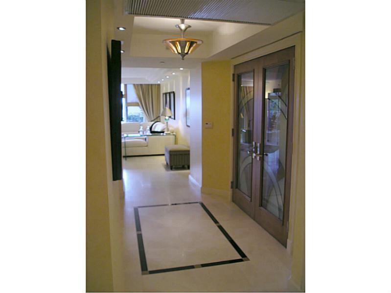 Step from your private elevator through dramatic Art Deco glass doors into spacious living, formal dining & 60' entertaining flow-thru.  Floorplan expands to 2 balconies, outstanding views of lake & Miami skyline.  Breakfast area & terrace for casual dini ng.  Sophisticated attention to fine details including travertine floors with marble inlay designs, stair-stepped soffits, designer lighting, custom cabinetry, thermostatic shower, bidet, Jacuzzi (cont'd in attachment).