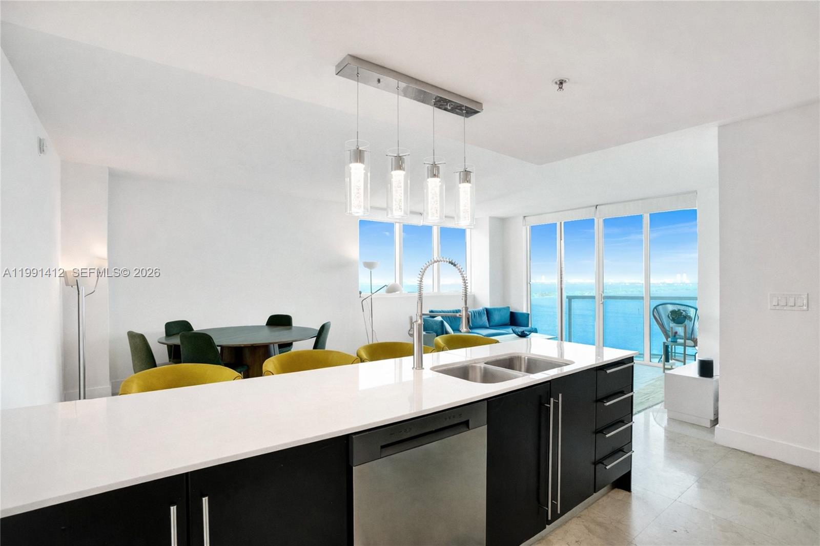 Stunning 2-Bedroom 2.5-Bathroom condo at Onyx on the Bay, offering luxury living with breathtaking city and water views. Features include marble floors, floor-to-ceiling windows, chef’s kitchen with stainless steel appliances, and a custom walk-in closet in the master suite. Enjoy two balconies totaling 175 square feet, including a stunning wraparound balcony with breathtaking views of the bay and city skyline, allowing you to experience both sunrises and sunsets from home. Amenities include a renovated infinity-edge pool, spa, sauna, steam room, and a fully equipped fitness center.