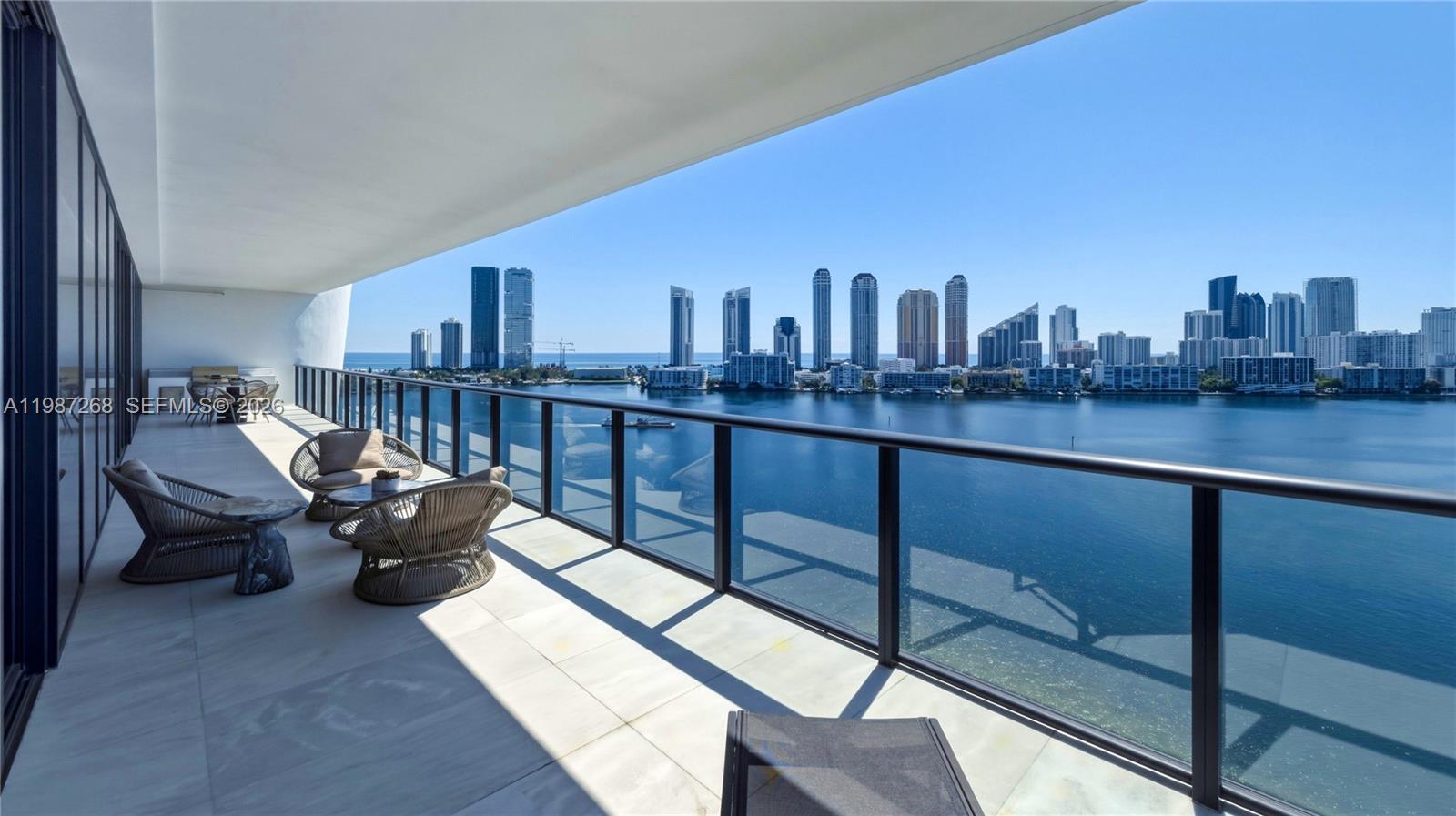 Move into this stunning, 4-bedroom, 5.5-bathroom residence offering 3,927 SF of luxury island living on the 12th floor of Privé South Tower, the sole address on South Florida's last private island. A private elevator opens directly into your grand entrance foyer, where natural marble floors flow throughout. Floor-to-ceiling glass walls rise 10 feet high, framing unobstructed Intracoastal, Bay, and Ocean views from every room. The European-style kitchen features custom white Italian cabinetry and Miele appliances, opening to the expansive living and dining area. Deep 10-foot balconies on east and west exposures with outdoor summer kitchen for year-round entertaining. Five-star amenities include a 10,000 SF gym/spa with steam, sauna, massage rooms, fitness studio, private dining with catering, wine cellar, cigar lounge, social room, toddler's playroom, resort pools, tennis court, and 24-hour security on a gated island. Includes a 65-foot boat slip and 3 covered parking spaces. Minutes from Aventura Mall, Bal Harbour Shops, top schools, and both airports. Steps from your yacht to your elevator, this is the boater's dream. Sold as-is. Privé stands as the crown jewel of the Williams Island community in the City of Aventura. Unparalleled luxury and complete privacy, surrounded by water on every side.