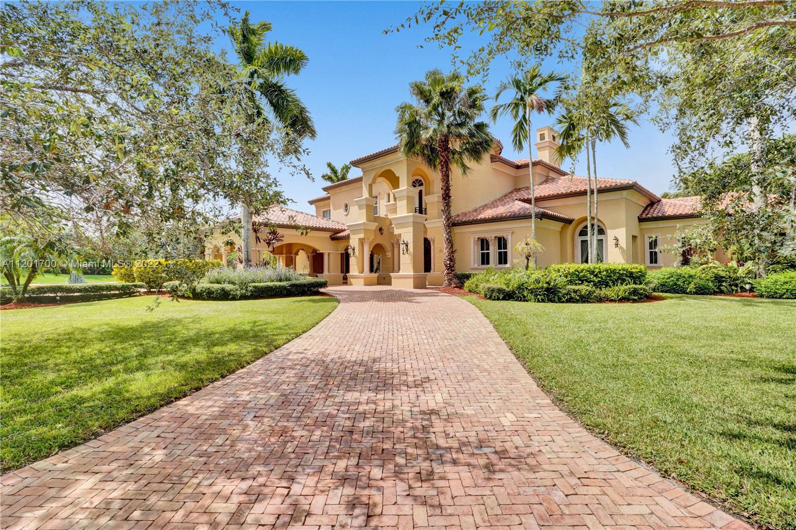 MAGNIFICENT two story estate nestled perfectly in the prestigious Windmill Ranch Estates on a 1.16 acre lake front lot! This Gallagher built custom home has every luxurious detail imaginable. Details include: grand Chicago brick pavered circular drive with oversized porte cochere, stunning foyer entry, soaring ceilings, gorgeous winding staircase, formal living & dining rooms, double sided gas fireplace, billiard room with bar & wine cellar, library/office, chef's delight gourmet kitchen with double islands open to a spacious family room, back staircase, elegant master bedroom suite with sitting area & breathtaking outdoor terrace, all bedrooms are mini suites with their own baths, resort style outdoor patios, summer kitchen, impressive pool with spa, 3 car garage & hurricane impact glass!