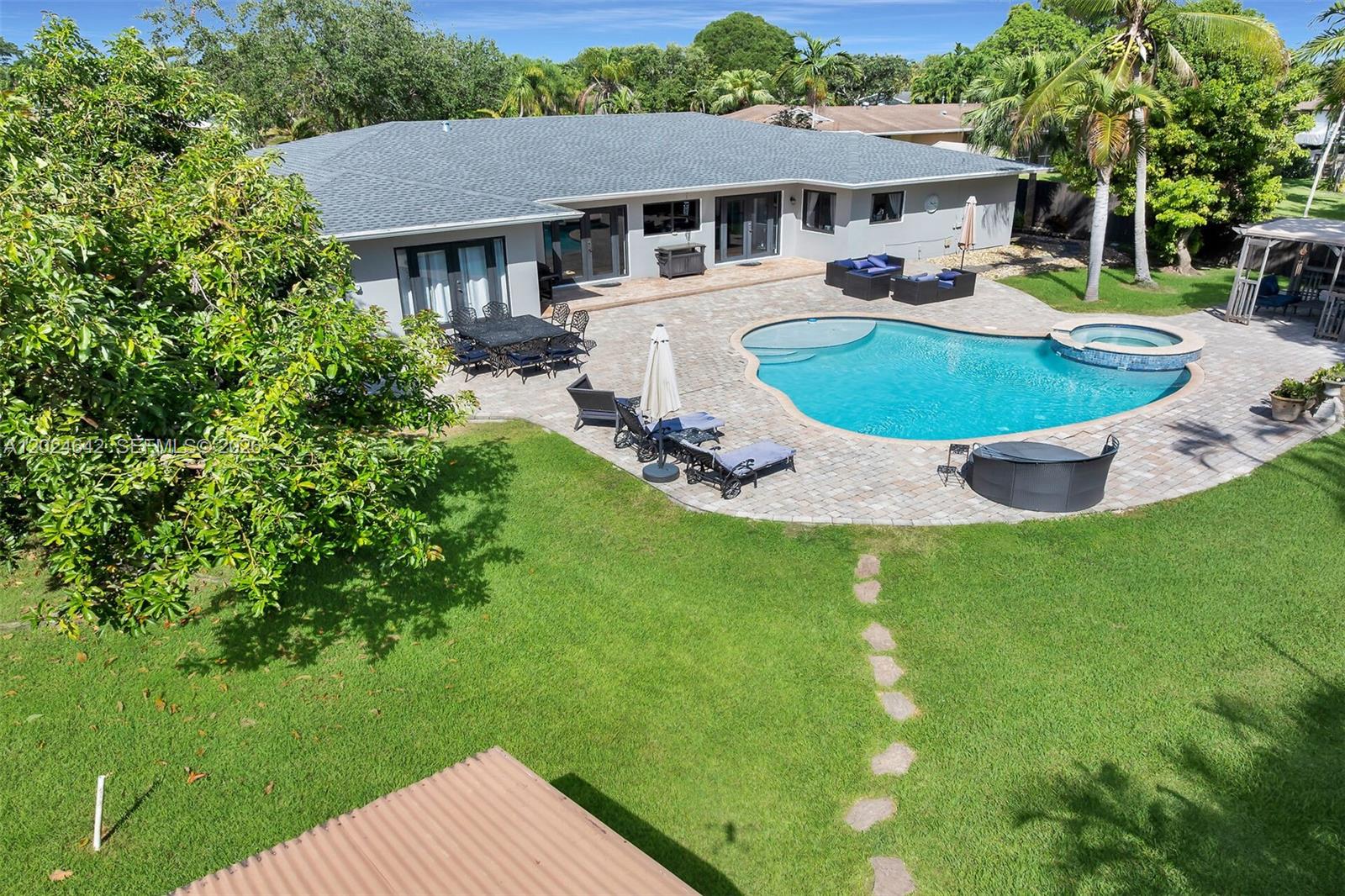 This is the Cutler Bay pool home you have been waiting for! This spacious and elegant 4 bedroom 4 bath home nestled in the privacy of a cul de sac and bordering a natural preserve will amaze you! Over 3700 sq ft under roof. Boasting a new roof and impact windows and doors, this home is storm ready and worry free for many years to come.With 3 bedrooms and 3 bathrooms on the west side of the home and a 1/1 on the east side that can serve as mother-in-law quarters.The large pool, hot tub and patio area are inviting you to entertain a large gathering. The large 2 car garage and backyard shed, with electrical, gives you plenty of room to store your toys. Ample parking for a large RV or a boat on the 1/2 acre lot. Inside the home you will find a safe room with a liberty safe, updated bathrooms and kitchen with a custom 9 ft island that can seat the whole family. This home is a must see if you are seeking privacy and large living spaces!