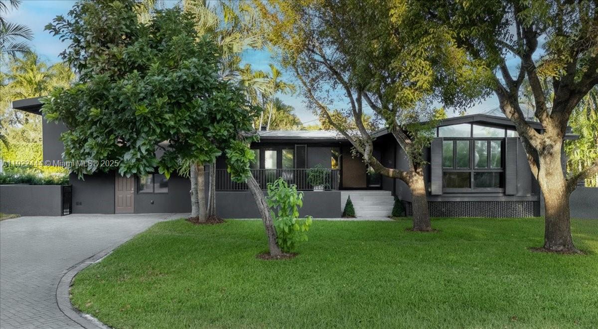 A beautifully reimagined home on one of Key Biscayne’s most desirable streets, South Mashta Drive. With its bold charcoal façade and distinctive presence, this residence stands out immediately while maintaining a warm island charm that makes it feel welcoming from the moment you arrive. Surrounded by mature trees and lush greenery, the setting offers both atmosphere and privacy.

Inside, vaulted ceilings and expansive windows fill the space with natural light, creating a soft and inviting ambiance. The great room features a stone fireplace, wide-plank wood floors, and a natural flow to the terrace and pool, bringing effortless connection between indoor comfort and outdoor enjoyment. Every space reflects a carefully curated, cozy feel that enhances the character of the home.

The renovated master bathroom offers calming finishes and a serene atmosphere. A private suite provides the perfect accommodation for guests or extended family. Set on a generous 10,000 sq ft lot and enhanced with impact windows, updated lighting, a newer roof, and thoughtful design details, this residence blends timeless appeal, warmth, and the unique island charm that defines Key Biscayne living.

A rare opportunity to own a home that feels both distinctive and deeply inviting, in one of the most coveted locations on the island.