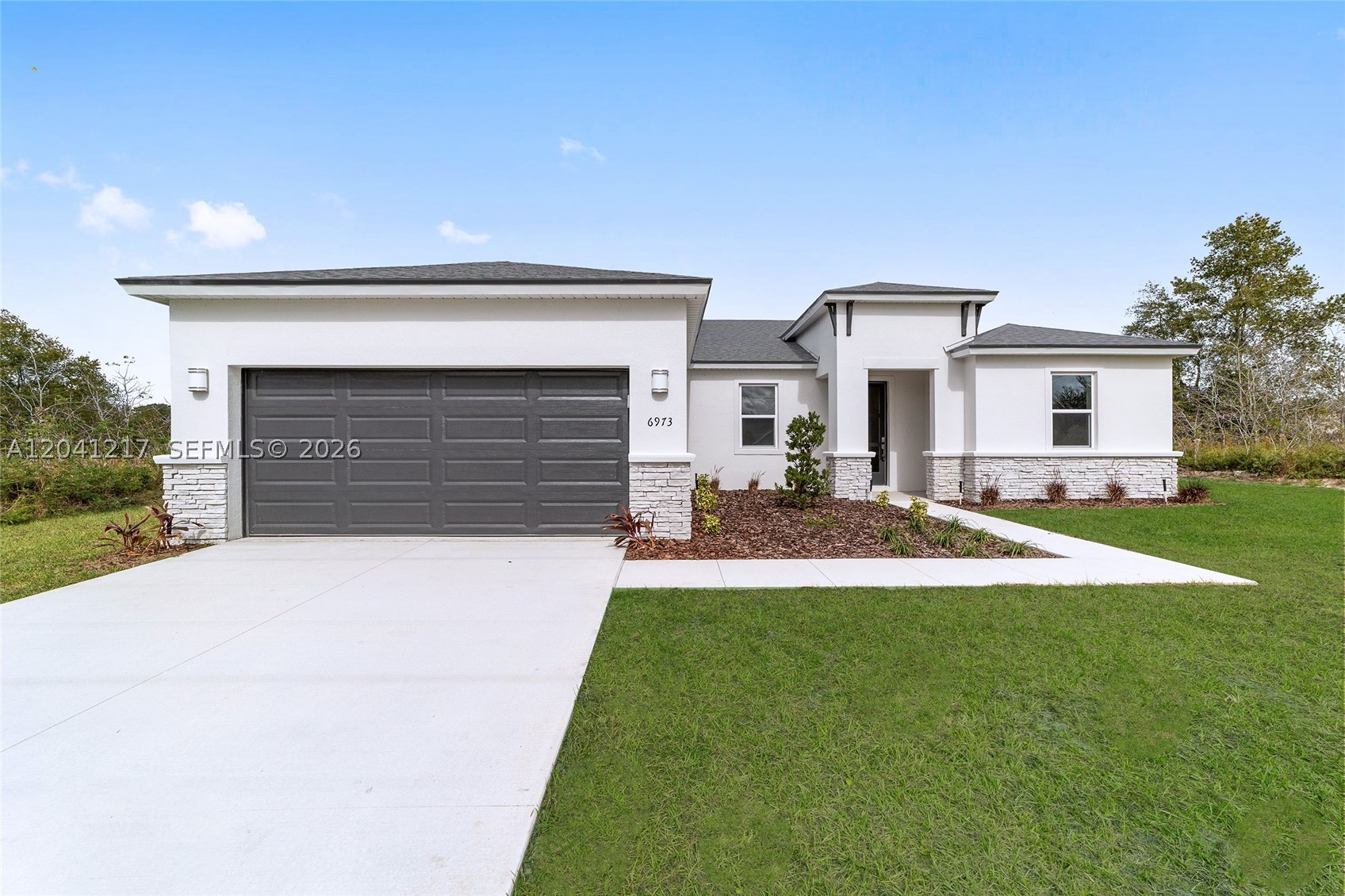 No HOA!! No CDD!! Standard features of this home include 36'' real wood soft close cabinets, quartz countertops, luxury tile plank flooring, 9'4'' ceilings, large walk-in closets, an irrigation system, rain gutters over septic area, hurricane shutters, a spacious open floor plan, Energy Star S/S appliances, double pane low emission windows that help control your home's internal temperature and reduce noise pollution, LED lighting, high performance 16 SEER HVAC unit. Designer landscaping. Pictures are from a previously built model.