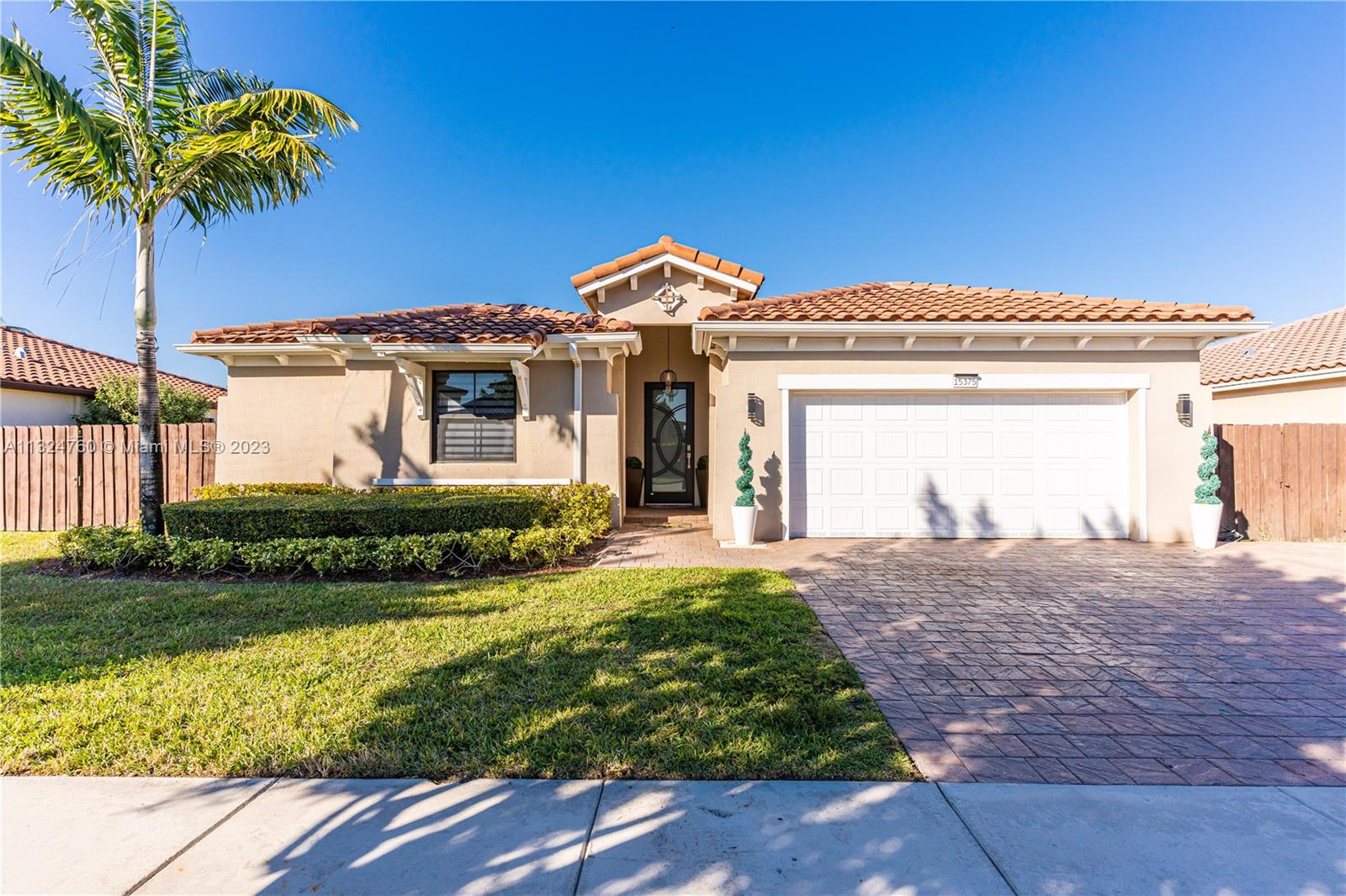 Making this home YOURS will have you living in luxury. This home is READY TO MOVE IN!! Some of this beautiful home's features are hurricane impact front door, tile throughout, ample living areas, tray ceilings in the bedrooms, zebra blinds, glass shower enclosures, brand new jacuzzi in master bathroom, spacious walk-in closets, large yard with immaculate concrete pavers, double sided gate for easy boat parking and access, wood cabinetry, modern fans, two sets of washer and dryer,  stainless steel appliances, spacious driveway, plenty of space for a pool and a privately sectioned 2 Master Suite In-Law Quarters. You are invited to come tour this wonderful home. It is also conveniently located in a NO FLOOD ZONE.