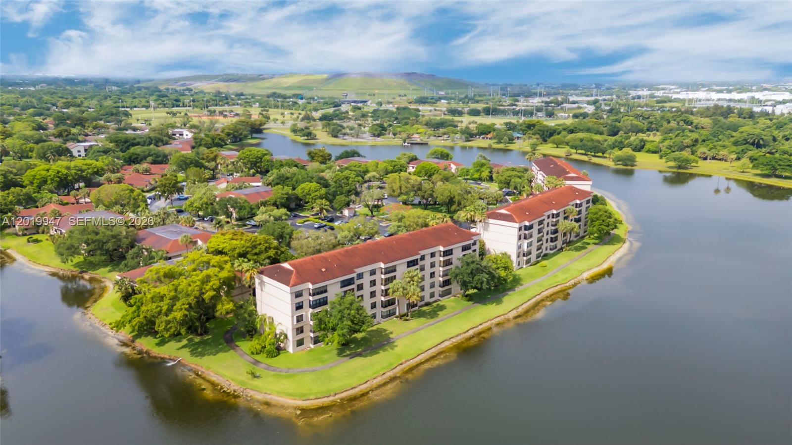 Welcome to this beautifully maintained 2-bedroom, 2-bath corner unit in the desirable Applewood Village II community of Coconut Creek! Located on the 4th floor, this spacious 1,300 SqFt condo offers stunning lake views, abundant natural light, and a functional split-bedroom floor plan designed for comfort and privacy.

Enjoy a bright eat-in kitchen with pantry, spacious living and dining areas, walk-in closets, built-ins, and an in-unit laundry room for added convenience. The home also features hurricane shutters, luxury vinyl plank flooring, ceiling fans and plenty of storage throughout.

Relax in your private corner-unit retreat overlooking the peaceful lake, or take advantage of the community amenities including a heated pool, clubhouse, tennis courts and guest parking.

The monthly HOA fee is $843.04 and includes water, garbage, insurance, lawn care and maintenance, clubhouse and pool access, plus 600 Mbps Comcast internet and cable. In addition, the Township master HOA fee is $180 quarterly and offers resort-style amenities including a gym, tennis, pickleball, basketball, paddleball, and racquetball courts, locker rooms, personal training services, an aquatic center with Olympic-size pools and sauna, a kids’ pool, and a movie theater/performing arts center.

Conveniently located near shopping, dining, parks, major highways, and top-rated schools. Don’t miss this incredible opportunity to own a spacious waterfront condo in the heart of Coconut Creek!