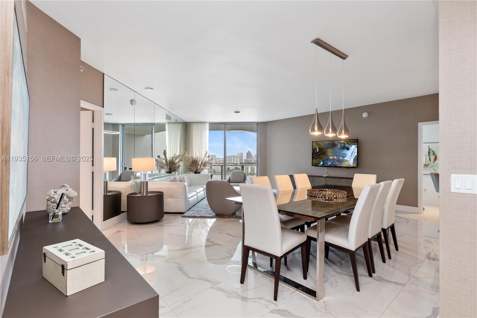 Introducing a stunning waterfront furnished unit featuring 2 spacious bedrooms and a generous Den converted into a third bedroom, along with 3 full baths. This thoughtfully designed floor plan, maximizes space and efficiency! The unit boasts tasteful decor by a professional interior designer, with meticulous attention to details, including elegant wallpaper throughout and marble style look tile flooring. Enjoy the expansive balcony, offering breathtaking views of the Bay. 
The condo provides marina access for boats up to 100 feet with direct access to the ocean. A relaxing  pool deck with a BBQ area overlooking the bay. It also provides a gated community with 24 hrs security, business center with a cafeteria, party room, concierge services, and a state-of-the-art gym equipped with technogym equipment. Its conveniently located near Costco, fine dining restaurants, Aventura Mall, Bal Harbour shops, nearby public parks offering a variety of recreational options, including pickleball, tennis, basketball courts, soccer field, mountain biking and golf course and much more.