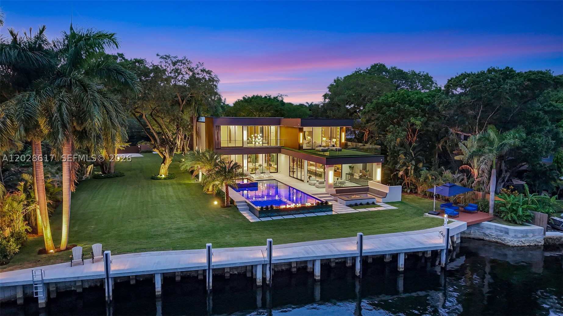 FULLY GATED COMPOUND — Brand new 2026 waterfront estate set on a sprawling ¾-acre (33,600 SF) private double lot measuring approximately 250 ft. deep by 134 ft. wide, with 134 ft of prime deeded wide-river frontage and breathtaking downtown skyline views. Offering just under 6,700 SF under AC and nearly 9,800 total SF, this exceptional residence features 6 bedrooms, 6 en-suite baths, 2 half baths, and integrated Lutron and Control4 smart home systems. Designed for grand-scale luxury living, the estate includes a private movie theater, commercial elevator, steam room, and a resort-style saltwater pool and spa. The expansive grounds provide ample space for an additional residence, guest retreat, or amenities such as a pickleball or tennis court, mini golf course, or other recreational features—creating a true private waterfront compound. The 100+ foot driveway leads to a 3-car garage designed to accommodate up to 6 vehicles with lifts, Additional side alley access allows discreet parking for an RV, motor coach, or additional watercraft. Outdoor living is elevated with a fully equipped summer kitchen, gas fire pit lounge, and a spectacular 23' x 48' saltwater pool with an 8' x 12' spa.

A brand-new seawall and concrete dock can accommodate a 100-foot yacht plus an additional 25–30-foot vessel, or a mega yacht up to 125 feet. Surrounded by mature trees and lush tropical landscaping, this exceptionally private estate offers a rare and unparalleled South Florida luxury offering.