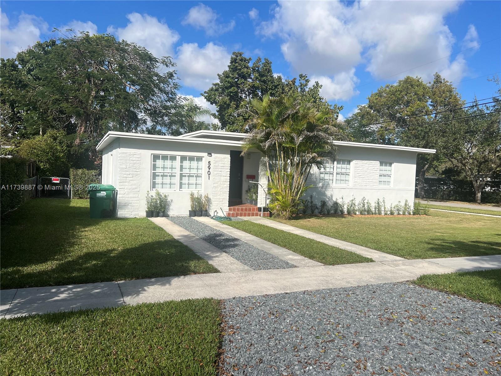 Charming 3-bed, 2-bath home in Riviera Estates. Features a quaint exterior with white facade and brick accents. Modern kitchen with white cabinets, quartz countertops, stainless steel appliances. The spacious living areas are filled with natural light, creating a warm and inviting atmosphere. Large backyard with mature trees. Ideal for peaceful living with easy local access.