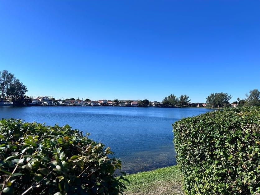 Welcome to this 2/2 in Beautiful Lago Grande with a pretty lake view from the bedroom, enclosed balcony and front of the home. A/C is less than 5 years old. Lago Grande has 3 guarded entrances and security that drived around the community. Lago Grande also offers amenities that include three swimming pools, clubhouse, playground and a basketball court. This community is centrally located close to major highways such as I-75, Palmetto Expressway and Okeechobee Road. It is also near supermarkets, shops, restaurants, medical, great schools and plenty of entertainment.