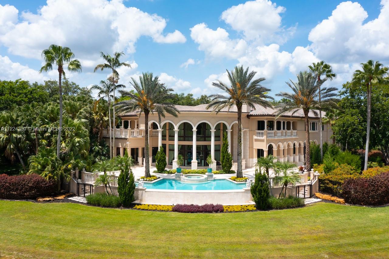 Gorgeous Italian Inspired Estate is now available for you! Hidden away on 1.7 acres and bordered by water on all sides. Marble and granite that are of a sturdy construction and can be found all around the home. The vast grand room has a glass wall that extends from the floor to the ceiling two stories high, guests will have a wonderful look at the waterfall pool that leads down to the extended lake vista. New Gourmet Kitchen equipped with top of the line appliances. A cutting edge Theater, Speakeasy Bar and Art Gallery! The estate also features two Fireplaces, Billiard Room; a Courtyard Entrance with a Koi Pond and Fountain; Putting Greens; Tennis Court; and Outdoor Kitchen. Hurricane impact and an automatic generator are also included. Truly one of a kind property you don't want to miss!