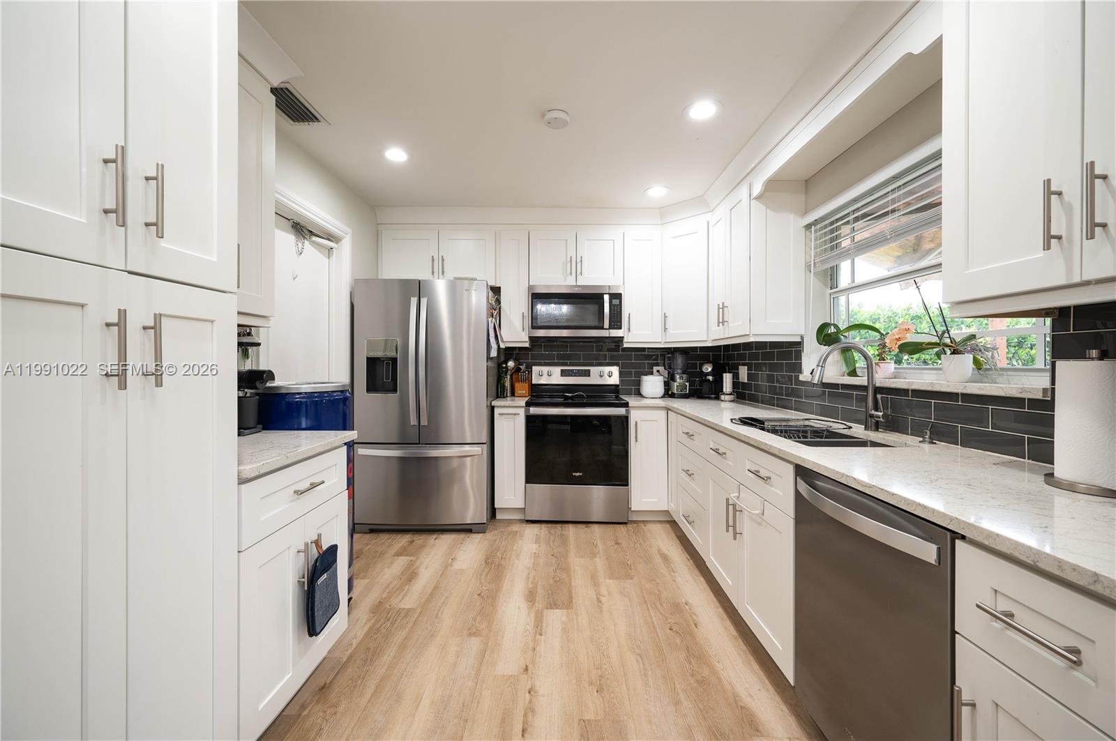 Experience the ultimate in waterfront elegance on this 8,000 sq. ft. lot overlooking a serene canal, where nature comes alive right in your backyard—watch ducks, exotic birds, fish, and turtles glide by as you relax in your private oasis.

This meticulously renovated home, updated seven years ago, boasts a modern kitchen with premium appliances, beautifully remodeled bathrooms, and rich wood laminate flooring throughout. High ceilings in the main living and dining areas create a bright, airy ambiance, perfect for both everyday living and sophisticated entertaining.

Entertain in style under the fully permitted covered pergola, comfortably hosting up to 10 guests, or enjoy tranquil moments surrounded by mature fruit trees and the gentle sounds of canal waters. Thoughtful upgrades include a new roof installed in October 2025 and impact doors, offering security without compromising style.

Practical touches like a canal-fed sprinkler system ensure your landscape stays lush with ease, while the home’s location offers unmatched convenience—combining waterfront serenity with access to everything the area has to offer.

This is a rare opportunity to own a move-in-ready waterfront retreat that embodies both refined living and a lifestyle defined by beauty, comfort, and peace of mind.