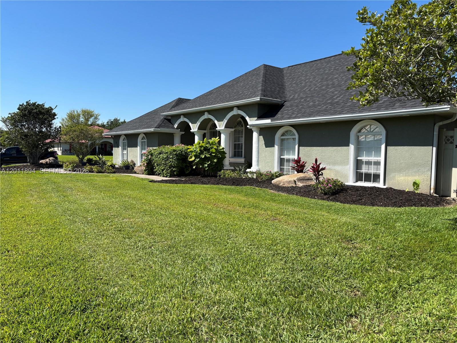 Very unique, spacious & adorable CBS home .32 Acre landscaped corner lot w/ room for pool. Attached 2 car garage & large circular driveway. 2074 SF under A/C, 3 Bedroom, 2.5 Bathrooms. Light & bright w/ beautiful 19.5" porcelain tile (laid diagonal) in the main areas. Arches & pillars accentuate the formal dining (13.5' x 16.5'...seats 16+) & living room (13.5' x22') areas.  Vaulted ceilings, crown moldings, statement lighting, wooden blinds upon bay windows and a variety window treatments provide a light & airy vibe. Double set of sliders enter the 18' x 44' screened in patio, great for outdoor BBQ & entertaining.  The kitchen has modern stainless steel appliances & elegant cherry finished cabinetry w/ crown molding, full sized pantry & breakfast area. Lovely Quartz on counter tops & kitchen back splash. The kitchen hallway leads to garage, half bath & utility room w/ Whirlpool front loading washer & dryer.  Second hallway leads to carpeted bedrooms w/ceiling fans and a guest bath w/ vanity, shower/tub combo and linen closet. The primary bath has a mirrored vanity, marble Roman tub, separate shower & walk in closet. ALL rooms fit KING sized beds. Hallway storage room can be used as computer room (wifi), nursery or extra walk in closet. The elegant front porch, chain link & privacy PVC fences offer other areas for animal or garden enthusiasts. Water softener, well & auto sprinkler systems included.$36,000 Roof 2023, AC 2023, water heater 2024. Call List Agent/OWNER for visit.