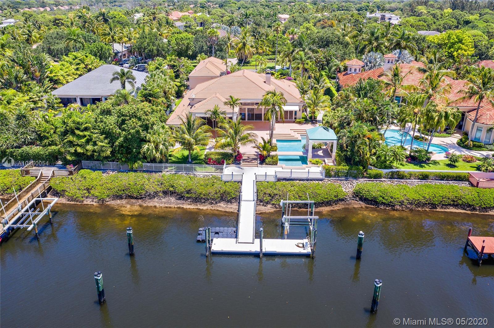 Vacant and Easy to Show! This custom home has a Rare Social Membership in Admirals Cove. The larger lot has 110 feet of waterfrontage perfect for a boater to have a larger vessel behind their home. Easy access to the Intracoastal waterways. The home has 5 bedrooms and 5 full baths and 2 half baths, 4 car garage, a theater room, and so much more.