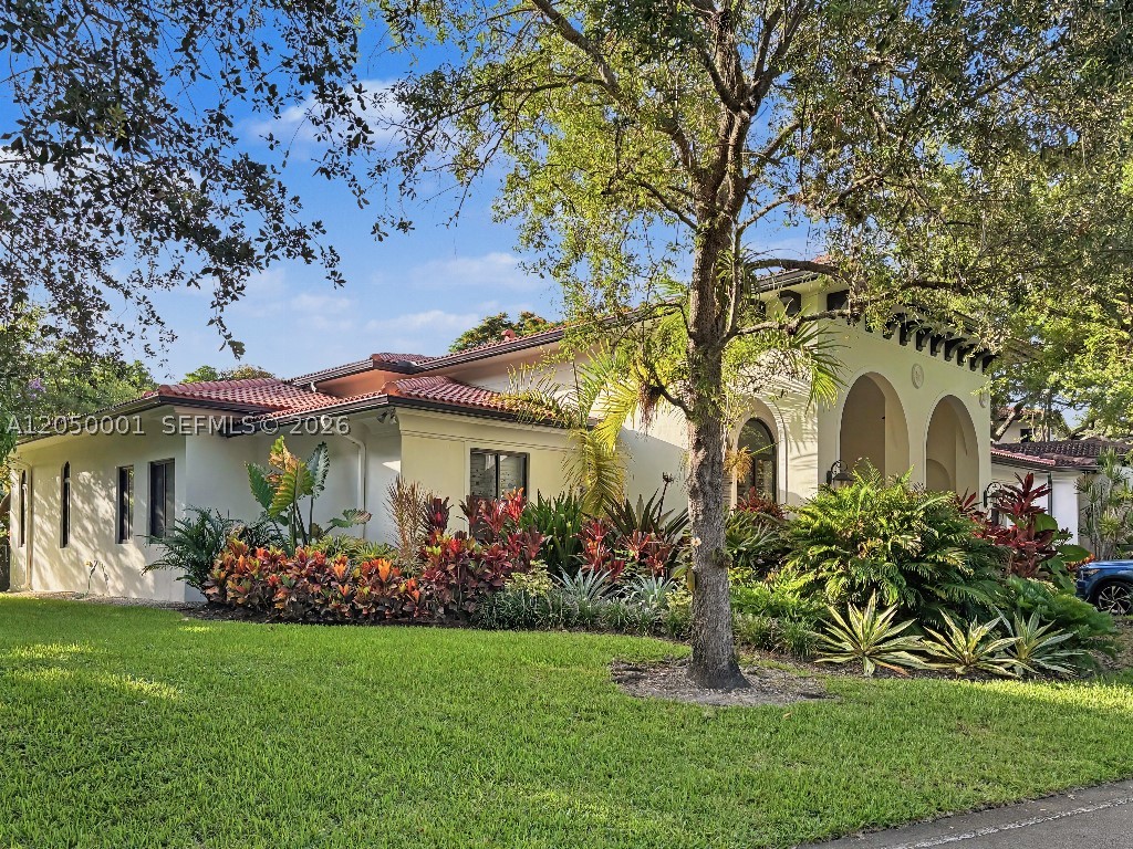 Rare offering in gated Smathers Four Fillies Farm, the 31-home Pinecrest enclave reserved for University of Miami faculty & employees — formerly the residence of a UM President. Renovated 3BR/2.5BA CBS home (2007), 2,453 SF, with soaring 15-ft ceilings in foyer & living room, wide-plank ceramic floors & abundant natural light. Chef's kitchen: quartz waterfall island, Wolf induction cooktop, oven, microwave & vent hood, Sub-Zero refrigerator & wine cooler, Bosch 800 dishwasher (2026). Primary suite w/ two walk-in closets & spa bath w/ separate tub, shower & water closet; hallway office nook w/ built-in desk. 2nd bedroom w/ renovated en-suite bath; 3rd w/ built-in Murphy bed. Screened porch, brick patio & fenced yard w/ mature landscaping & three mango trees. Storm-ready: impact windows, doors & garage door, strapped tile roof, generator hookup. New commercial water heater (2025), Ecobee thermostat, epoxy-floored 2-car garage w/ EV charging. Community pool, tennis, clubhouse & fitness center. Steps to Pinecrest Gardens; Pinecrest Elementary & Palmetto schools. Per community bylaws, buyer household must include UM faculty/staff occupant.