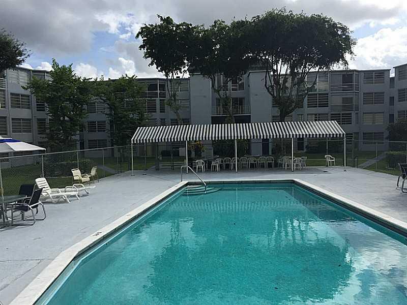 READY TO MOVE IN! WARM & BRIGHT LARGE 1 BEDROOM 1.5 BATH CONDO IN NORTH EAST MIAMI-DADE.  LIGHT TILE FLOORS THROUGHOUT AND CARPET IN THE BEDROOM.  LARGE ENCLOSED PATIO WITH HUGE WINDOWS AND SLIDING GLASS DOORS THAT OVER LOOK THE POOL AND BEAUTIFUL GARDENS . BIG WALK-IN CLOSET WITH BUILT INS. NEWER WATER HEATER. CONVENIENT FIRST FLOOR LOCATION IN ROLLING GREEN. CLOSE TO RESTAURANTS AND SHOPPING. FURNITURE FOR SALE. LOW MAINTENANCE. THE ASSOCIATION SAYS 55+. EASY TO SHOW.