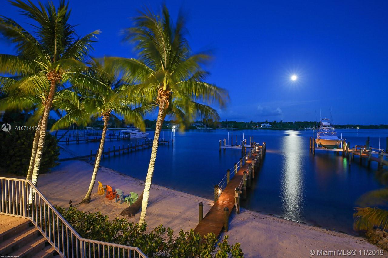 INTRACOASTAL PROPERTY - Over 80' of Direct Intracoastal Frontage with blue water for as far as your eyes can see. This property is for all water lovers including a sandy white beach. Custom built in the prestigious Indian Hills this home is perfectly situated with a southeast exposure & has thought in all the details that's sure to impress. Once entering the home you'll be swept away with the water views. The first floor has a large family room that is open to the kitchen, a spacious master suite, a guest bedroom, formal dining room & an office with custom built-ins. The 2nd floor has 2 additional guest rooms & a sitting area where you will get lost in views. 4 car garage, impact windows, a generator, and a dock for a large vessel - this home is a masterpiece on the Intracoastal.