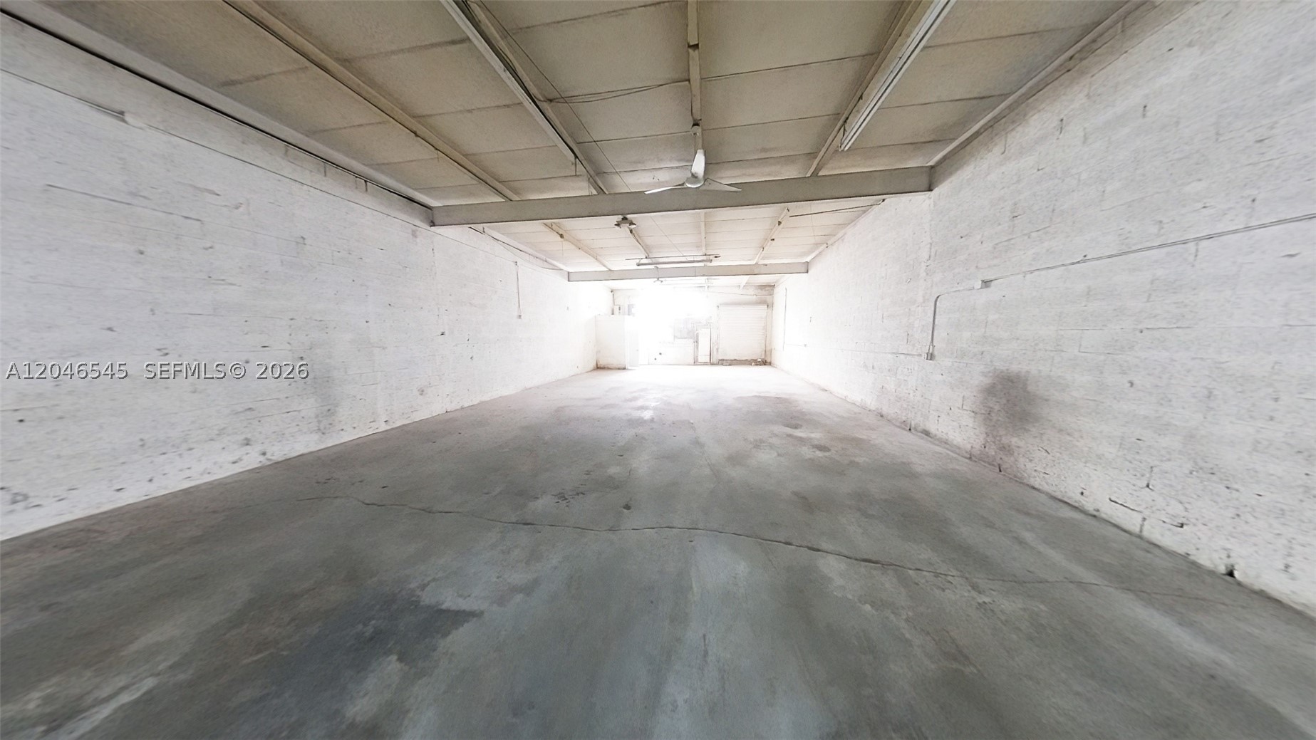 Warehouse with small office, open bay, restroom and shower.