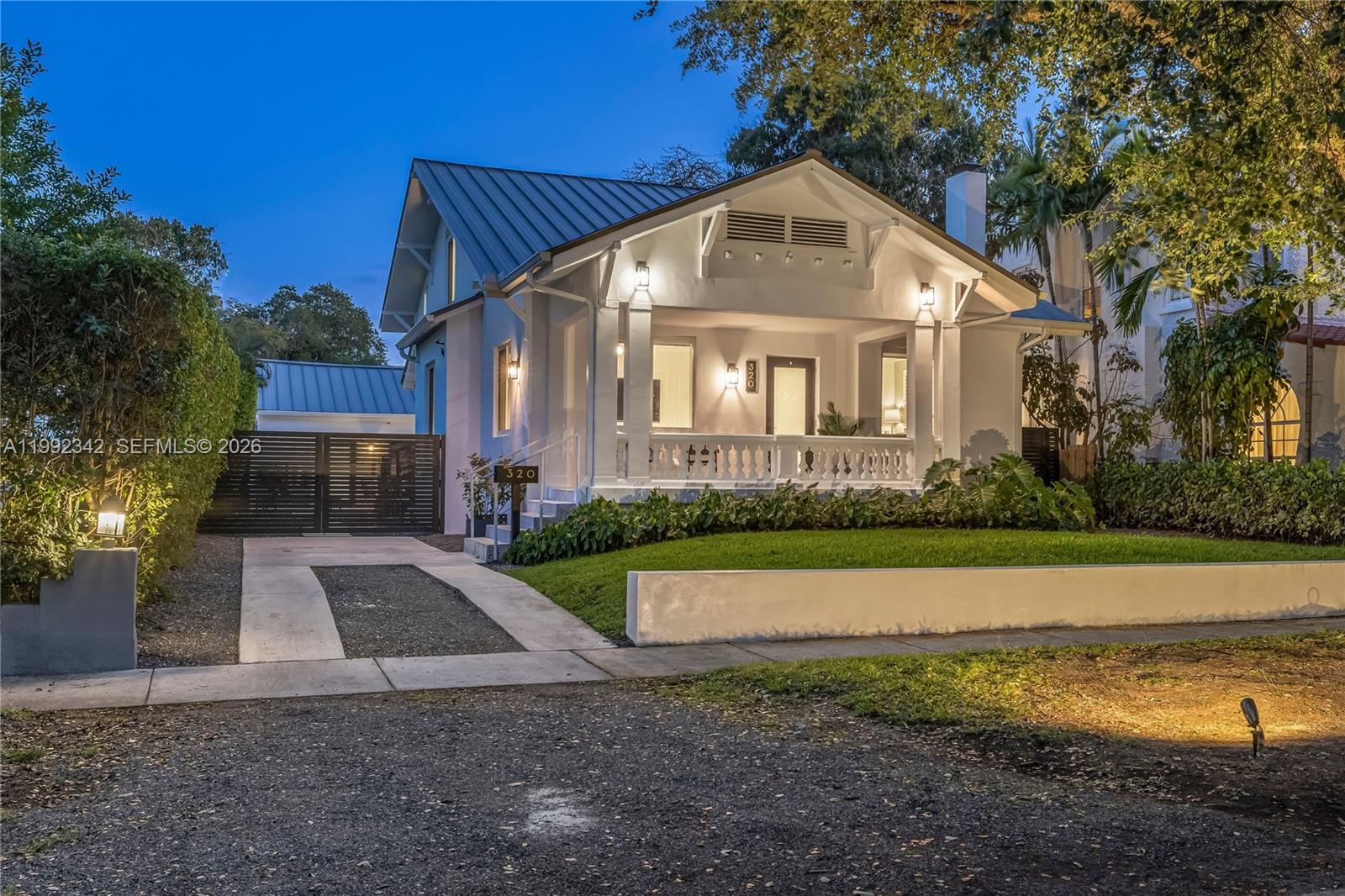 This one is special! Introducing Le Château, a fully reimagined 1925 estate in the lush enclave of El Portal—where historic architecture meets curated modern living. This rare offering includes a 4-bedroom, 3-bath main residence plus a detached 1-bedroom, 1-bath guest house, totaling 5 bedrooms and 4 baths across 3,300+ SF. A gracious front porch opens to grand interiors with soaring 10-foot ceilings, layered plasterwork, sculptural coffered details, and museum-quality crown moldings. Restored hardwood floors run throughout, anchored by a marble fireplace, with custom built-ins and a formal dining room creating an elegant yet inviting setting. The redesigned kitchen blends clean modern finishes with functionality while honoring the home’s architectural soul. The main level features a spa-like primary ensuite and an additional guest bedroom with full bath. Upstairs offers two bedrooms, a shared bath, and a charming loft retreat. Thoughtfully upgraded with impact windows and doors, metal roof, electrical, plumbing, and HVAC—this is a true turnkey residence. Outdoors, marble-clad patios and manicured grounds create a private setting with room for a pool. The detached guest house offers flexibility for guests, office, or income. Set beneath a majestic oak canopy in a non-flood zone on one of El Portal’s most picturesque streets—there is truly nothing else like it.