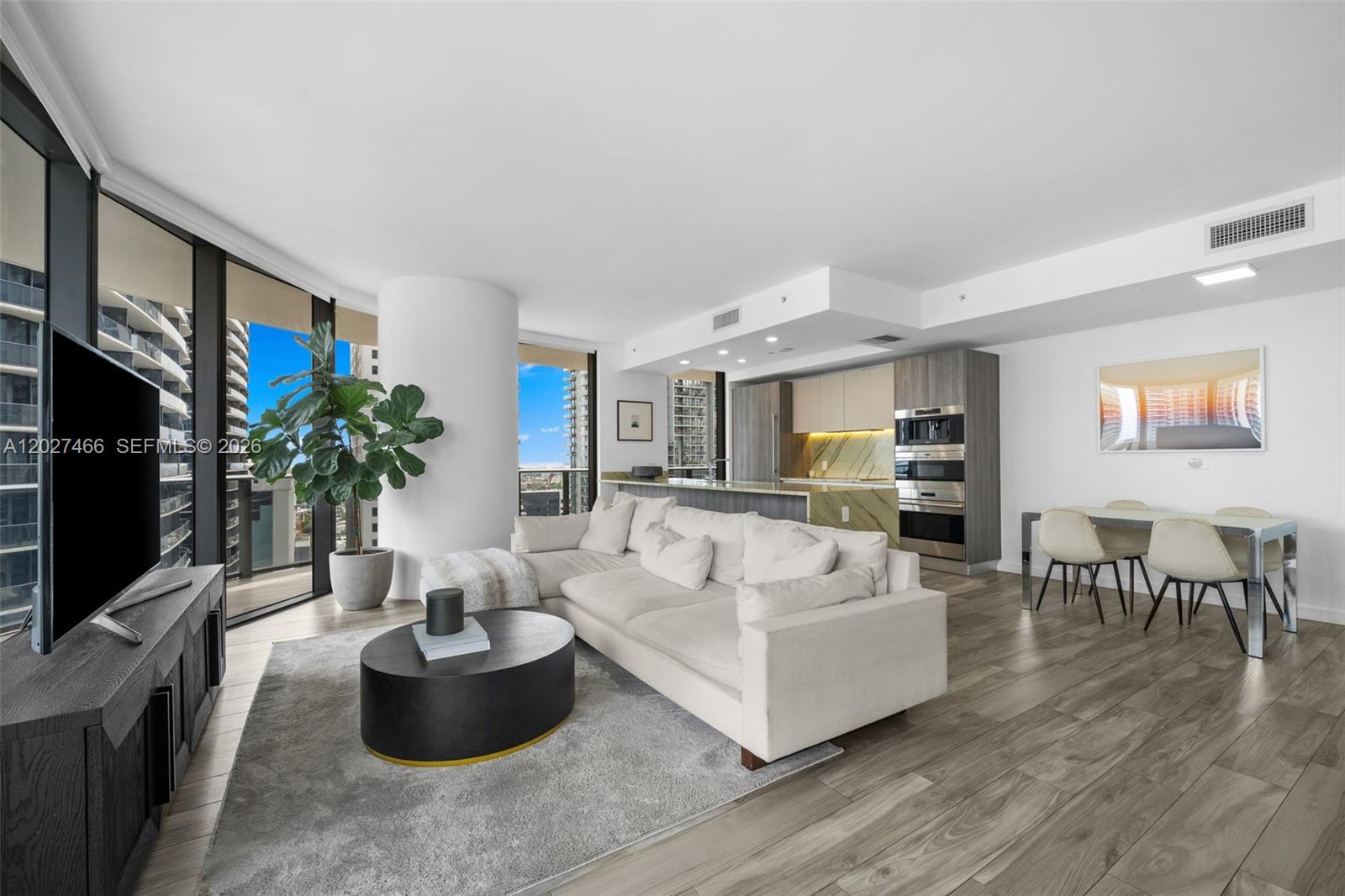 Stunning corner residence at SLS LUX in the heart of Brickell featuring sweeping Miami skyline and partial bay views through floor-to-ceiling windows that fill the home with natural light, while the expansive wraparound terrace creates seamless indoor-outdoor living throughout the main living areas. The elegant marble kitchen is beautifully appointed with premium Wolf and Sub Zero appliances, including a wine cooler and built-in coffee system, along with extended custom cabinetry for both style and functionality. The oversized primary suite offers direct terrace access, a spacious walk-in closet, and a spa inspired bath featuring dual vanities, a soaking tub, and a separate glass enclosed shower. A fully enclosed den/laundry room enhances the home’s functionality. The residence also features a private elevator foyer entry with attached storage. Smart home upgrades such as motorized blinds and voice controlled lighting elevate the living experience. Residents of SLS LUX enjoy resort style amenities including a rooftop infinity edge pool with panoramic skyline views, additional resort pool deck, full service spa, state-of-the-art fitness center, tennis court, resident lounge, 24 hour concierge and valet services, and more. All just steps from Brickell City Centre, Mary Brickell Village, and premier dining and shopping. 2 assigned parking spaces + 1 valet space are included.