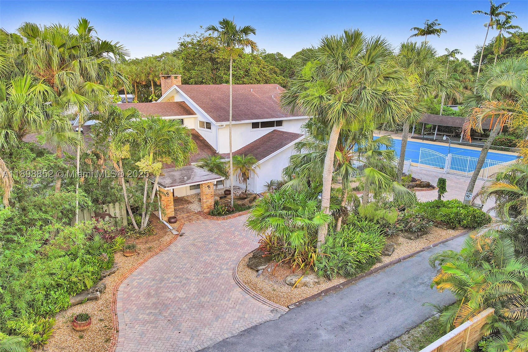 Most homes offer features — this one delivers a true private resort-style compound in the heart of Fort Lauderdale. Located in the quiet and highly desirable Riverland neighborhood, this exceptional 5-bedroom, 3-bath estate spans over 22,400 sq ft across two separate folio lots, offering a level of space, privacy, and lifestyle that is incredibly rare this close to everything.

The sale includes both the main homesite and the adjacent recreational lot, creating a unique double-lot property with endless flexibility and long-term value. The second lot is home to a full-size private tennis court with basketball hoop — an amenity almost never found in residential Fort Lauderdale properties and one that transforms the estate into a true private retreat.

Inside, the home welcomes you with soaring ceilings, expansive living areas, and abundant natural light throughout. Designed for both entertaining and everyday comfort, the layout features a modern chef’s kitchen with center island, multiple gathering spaces, and a spacious game room offering added flexibility for family and guests.

Step outside and experience your own secluded backyard oasis surrounded by lush tropical landscaping. The heated screened-in pool creates the perfect year-round setting for relaxing or entertaining, while the oversized grounds provide exceptional privacy and open space rarely available in this location.