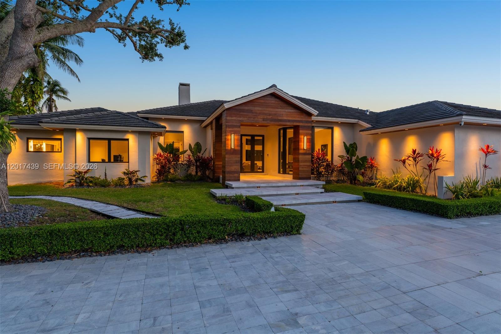 Exquisitely renovated 5-bedroom, 6-bath residence offering 4,643 Sq.Ft. of living space in prestigious gated Leewood Estates. Thoughtfully redesigned with a refined blend of sophistication and comfort, this exceptional home features impact glass throughout, custom millwork, elegant built-ins, curated cabinetry, and a state-of-the-art Crestron smart home system controlling lighting, audio, climate, security, and entertainment. The chef’s kitchen is equipped with premium designer appliances, including a 72-inch Sub-Zero refrigerator and the rare convenience of three dishwashers. The luxurious primary suite offers spa-inspired finishes with a floating soaking tub, dual vanities, makeup station, and expansive walk-in closets. Sophisticated living spaces include a private office, decorative fireplace, stylish bar, and seamless indoor-outdoor flow ideal for entertaining. The former 2-car garage has been converted into a bespoke game room with flexibility to revert back. Outdoors, enjoy a summer kitchen, cabana bath, landscaped entertaining areas, and a resort-style pool with both heater and chiller for year-round enjoyment. Residents enjoy private community tennis courts within this exclusive gated enclave.