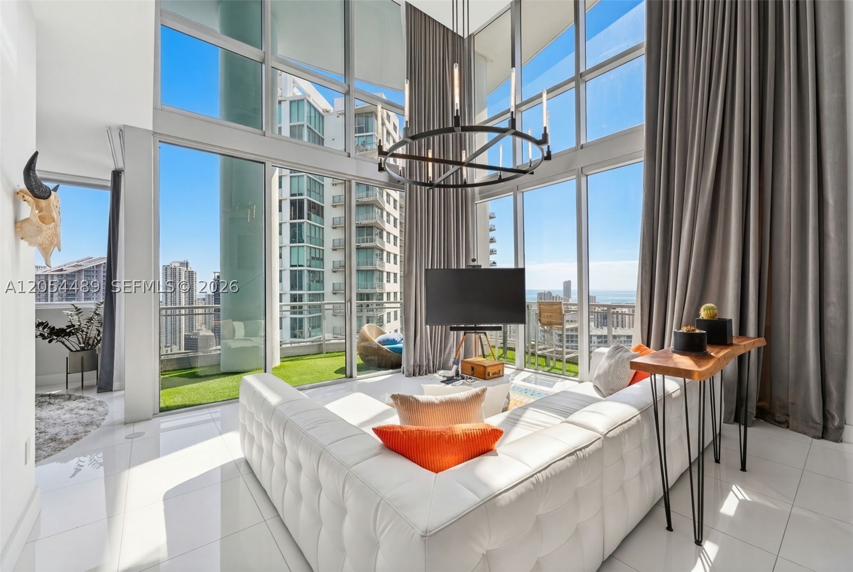 Largest total square foot penthouse at Riverfront. IVY PH-12 in Miami, this one-of-a-kind three-story penthouse offers an unmatched blend of luxury, space, and breathtaking design. As the largest residence at Riverfront, the home spans approximately 4,500 total square feet, including an extraordinary 2,000 sq. ft. private rooftop terrace complete with a jacuzzi-perfect for enjoying sweeping 360-degree views of the city and river. Inside, the dramatic living room showcases soaring 20-foot ceilings, creating a bright and open atmosphere ideal for both relaxing and entertaining. The oversized primary suite is a true retreat, featuring motorized curtains and a custom marble bathroom with a spacious soaking tub and separate shower. The second bedroom is currently unfurnished, offering flexibility to be customized by either the owner or tenant. The third bedroom has been thoughtfully designed as a state-of-the-art home fitness center. This exceptional penthouse is available furnished for an annual lease, delivering a rare opportunity to experience elevated Miami living at its finest. Across bridge from Brickell City Center. Rented for $15,000/month until July 2027. Includes 2 parking spots on level 2, two storage units and two motorcycle spot at list price. Sold furnished!