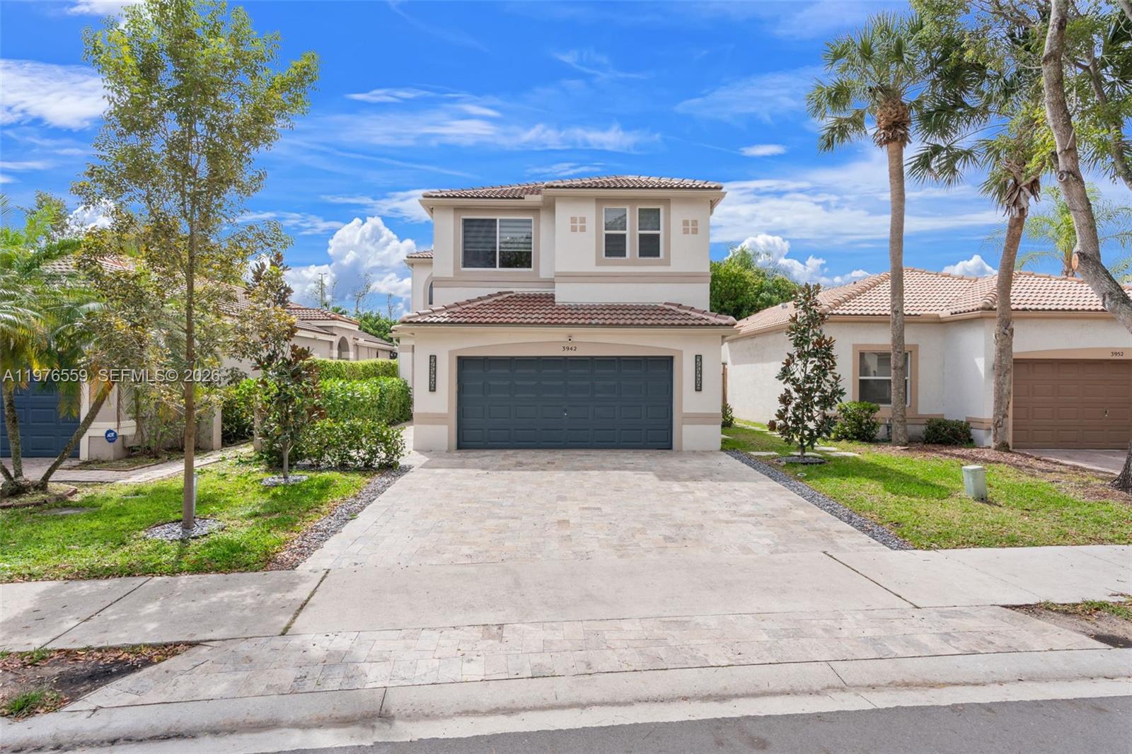 Located in the highly desirable gated community of Cocobay, this renovated 4-bedroom, 2.5-bath home is truly move-in ready with high-end upgrades completed from 2023–2025. The thoughtfully designed floor plan includes a versatile entry-level bedroom ideal for guests or private home office. In 2023, the first floor was fully remodeled and a 4th bedroom was added and new kitchen. Major system upgrades include a full-home plumbing repipe, new main electrical panel, updated electrical work, new lighting throughout, new A/C with first-floor ductwork, smart thermostat, and a custom living room feature wall.  Outdoor living was transformed in 2024 with a newly built saltwater pool featuring a heater and spa, silver travertine paver patio, new driveway and front walkway, professionally turfed backyard, and upgraded exterior lighting. In 2025, additional upgrades include a brand-new tile roof and gutters, hurricane-impact windows and doors, fresh exterior paint, new carpeting upstairs, Samsung smart kitchen appliances, resurfaced garage floor, new garage entry door, EV charger, new hot water heater, whole-home water filtration system, and remote-control motorized blinds throughout.  This home offers peace of mind with extensive mechanical, structural, and cosmetic upgrades already completed. A rare opportunity to own a beautifully upgraded property in one of Coconut Creek’s most sought-after communities. Please note: Outdoor kitchen and cold plunge are excluded from sale.