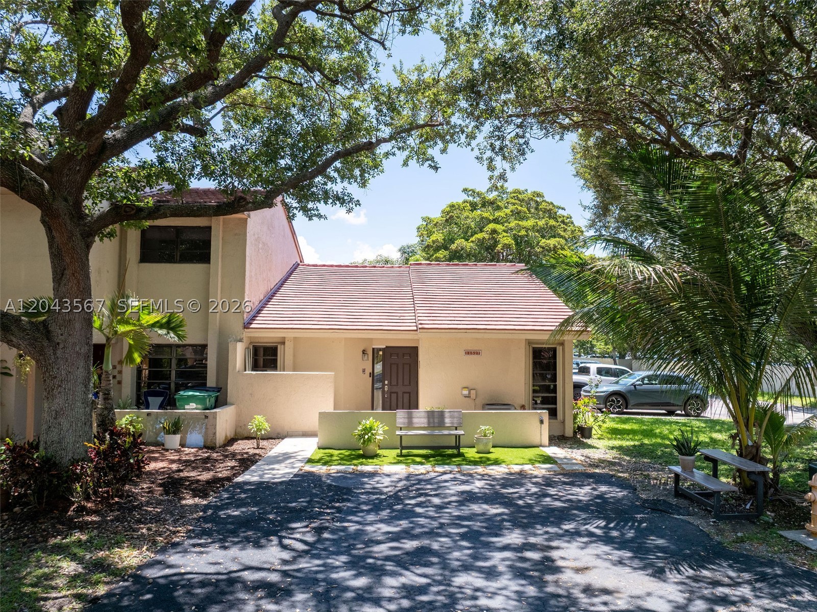 Beautifully updated corner-unit residence located in the highly sought-after Green Street Townhomes community in the heart of Kendall. Perfectly positioned with ample guest parking directly adjacent to the home, this exceptional 3-bedroom, 2-bath property offers privacy, convenience, and an unbeatable location just minutes from The Palms at Town & Country, premier dining, shopping, and immediate access to Florida's Turnpike.

Step inside to discover a bright and spacious open-concept layout featuring soaring vaulted ceilings, abundant natural light, expansive living and dining areas, and upgraded flooring throughout. The beautifully renovated kitchen is designed for both function and style, showcasing custom cabinetry, granite countertops, stainless steel appliances, generous eat-in seating, and seamless entertaining flow. The home also features tastefully updated bathrooms, oversized bedrooms, hurricane shutters for added peace of mind, and a private fenced patio retreat perfect for outdoor dining, entertaining, or quiet relaxation. Surrounded by mature shade trees and lush tropical landscaping, this move-in-ready residence offers an exceptional combination of comfort, style, privacy, and convenience in one of Kendall’s most desirable communities.