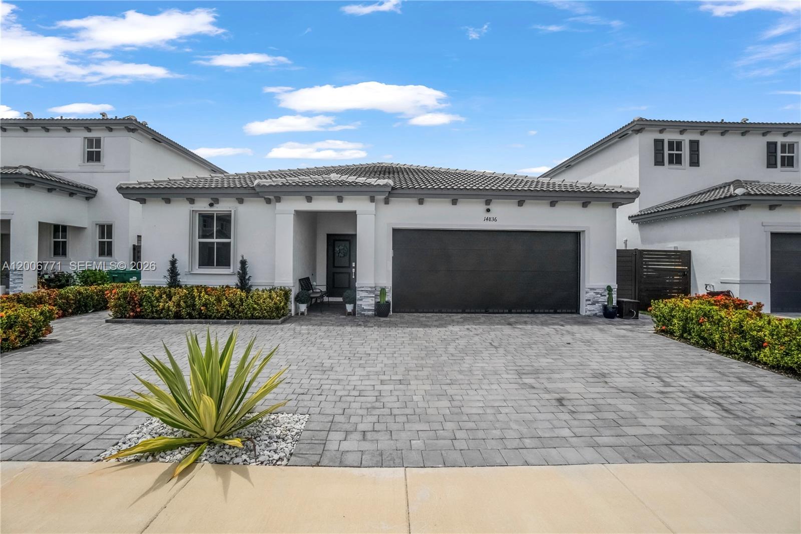 Beautifully designed 2024-built single-story smart home offering 3 bedrooms, 2 full baths, and 1 half bath across 1,736 sq ft of thoughtfully planned living space. The open-concept layout features a bright and airy living area flowing into a chef-inspired kitchen with sleek Samsung appliances, a large center island, and a beverage station with wine cooler perfect for entertaining. Upgraded vinyl flooring throughout, elegant interior plantation shutters, and hurricane accordion shutters on all windows provide style, functionality, and year-round protection. All bedrooms are generously sized and all bathrooms are spacious and well-appointed. The home is equipped with a smart home system and an EV charging station for modern convenience. A roomy 2-car garage provides additional storage and workspace. Step outside to a large, fully fenced patio on a 5,505 sq ft lot, an ideal canvas for a future pool, outdoor lounge, or private play area. Located in a pet-friendly community with a low $54 monthly HOA, this move-in ready 2024 gem delivers modern living in the heart of West Kendall, Miami 33187.