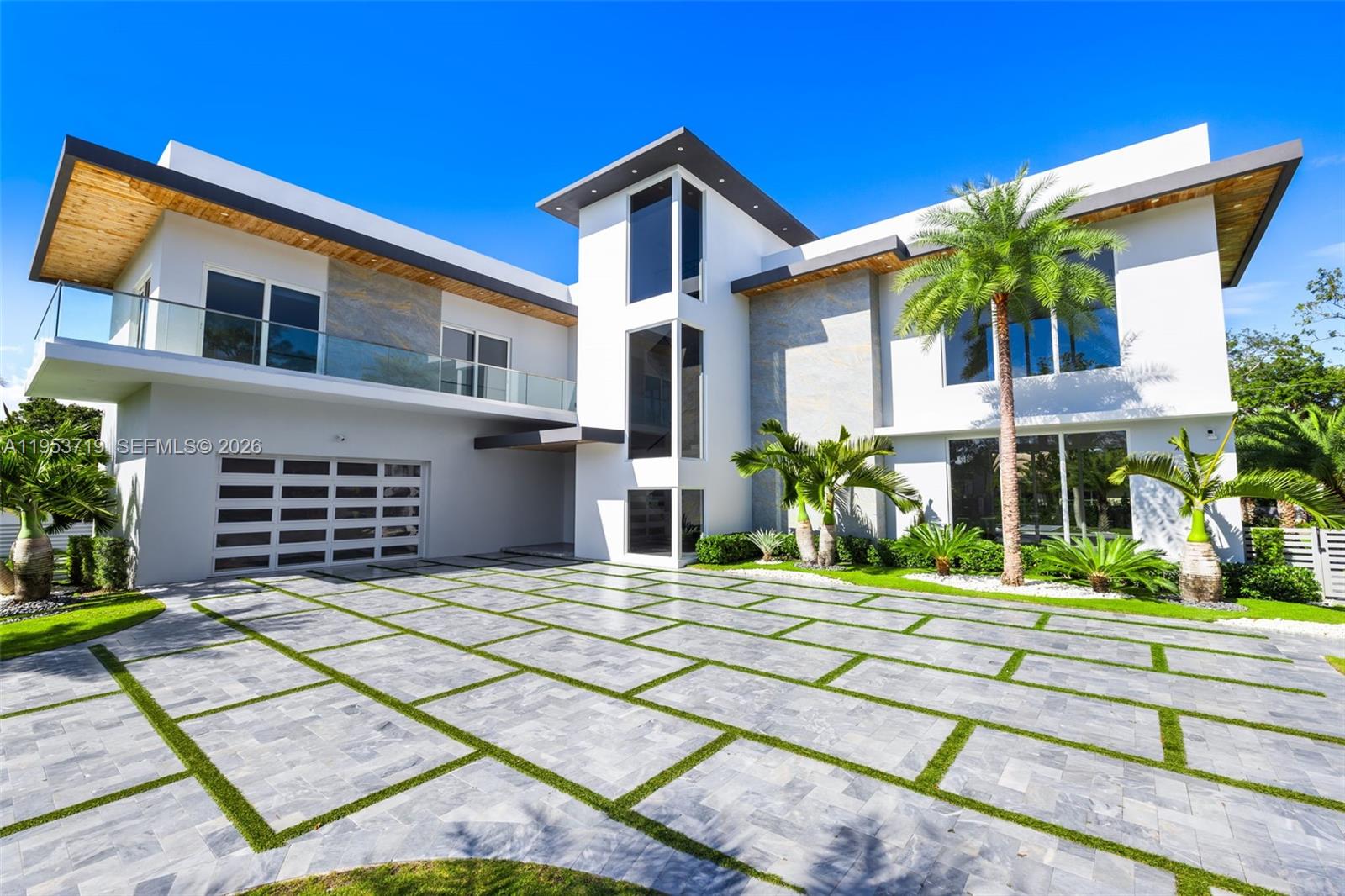 A recently completed modern residence offering refined scale, architectural clarity, and thoughtful design throughout. This home features five en-suite bedrooms plus a powder room, with soaring two-story ceilings anchoring the kitchen, entry, and primary entertaining spaces to create an immediate sense of volume and light.

Walls of expansive impact glass frame the outdoors and flood the interiors with natural light, while the open, well-proportioned floor plan is designed for seamless living and entertaining. The kitchen and main living areas flow effortlessly to the exterior, where a glistening pool, lush grassy yard, and private sports court create a true indoor-outdoor lifestyle.

The outdoor spaces are thoughtfully layered, featuring a poolside entertaining area with a covered summer kitchen. A rooftop sundeck, complete with a secondary grill, offers generous space to tailor the setting for open-air dining, lounging, and entertaining under the stars.

A detached cabana/guest suite offers flexibility for guests, work, or recreation. The property is moments from the bay, with coastal breezes and a tranquil setting that enhances everyday living.

Located in one of the most desirable neighborhoods of Palmetto Bay, this is a turnkey modern home defined by scale, light, and quality, ideal for those seeking a refined yet relaxed South Florida lifestyle.