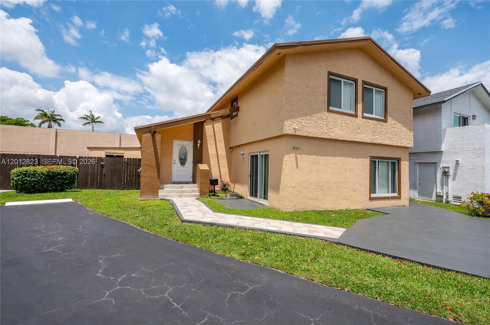 Welcome to this beautifully maintained two-story home in the gated Fairway Lakes Village community. This 4-bedroom, 3-bathroom residence offers 1,962 square feet of comfortable living with a versatile split-level layout—one bedroom and full bath on the main floor, ideal for guests or multigenerational living. Upstairs you'll find three spacious bedrooms and two baths. The updated kitchen features granite countertops, while the large resurfaced stamped-concrete patio overlooks a generous backyard. Recent updates include impact windows and a 2017 roof. Enjoy community amenities like a pool and playground, all just minutes from major highways, shopping, and dining. Seller willing to assist with seller concessions.