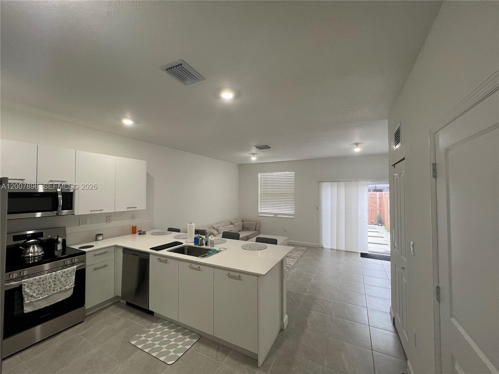 This new 3-bedroom, 2.5-bath modern townhouse opens with a versatile front nook perfect for a foyer or home office and flows into a bright open-concept living area anchored by a sleek white kitchen with quartz countertops, stainless-steel appliances, undermount sink, and a breakfast bar for four. Sliding glass doors lead to a private backyard oasis featuring concrete pavers set between faux-turf strips, framed by white river rocks and a wooden privacy fence — ideal for al fresco dining or evening relaxation.

Property rented through February 2027 with excellent tenants in place, making this a great turnkey investment opportunity. Seller willing to assist with a smooth transition.

Motivated seller — bring your best offer!