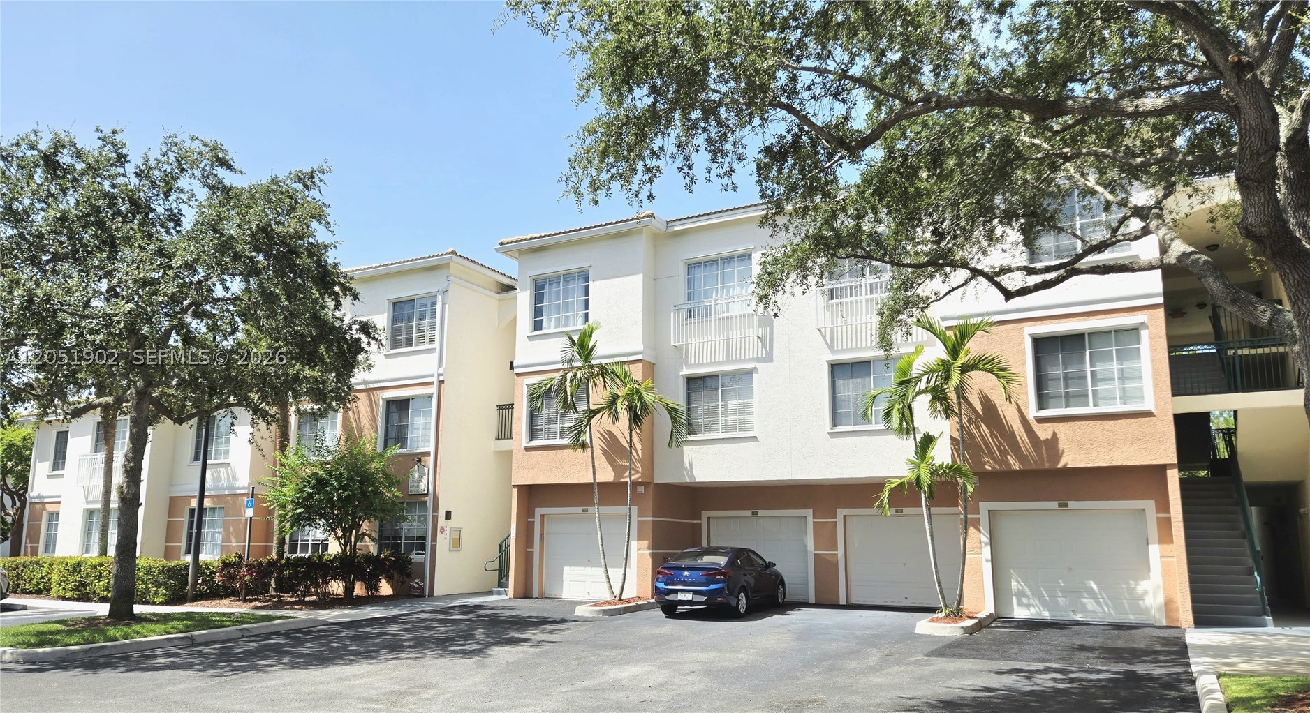 Spacious 1/1 Penthouse with Sunroom & Detached GARAGE G1-4 *Located Below Unit In The Same Building! Plus Additional Deeded Parking!  Live The Luxurious Life-Style of Fiore at The Gardens - a Gated, Privately-Owned Community!! Features High Ceilings, Crown Molding, Large Walk-In Closet, Full-Size Washer & Dryer, Newer Air Conditioning System (2023) & Water Heater.  Community boosts a Resort-Style Swimming Pool & Fitness Center, Screened Cabana with BBQ Appliances, a Children's Playground & Putting Green, a Sand Volleyball Court, a Car Wash with Vacuum & Air and More! Pets Welcome! (2) - up to 25lbs each*
