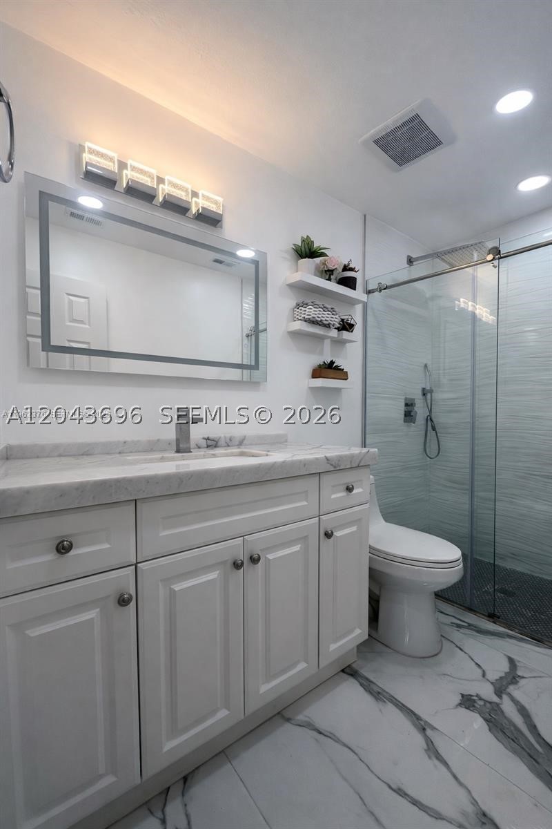Welcome to this beautifully updated 3-bedroom, 2-bathroom one-story townhome located in one of Hialeah's most desirable guard-gated communities, The Moors. This move-in-ready residence offers a bright, open floor plan with contemporary finishes throughout.

The home features a stunning modern kitchen with sleek white cabinetry, quartz countertops, dramatic full-height black stone backsplash, stainless steel appliances, and a convenient breakfast bar area. The spacious living and dining areas are filled with natural light, creating the perfect space for everyday living and entertaining.

The primary suite includes a beautifully remodeled en-suite bathroom with a frameless glass shower, elegant marble finishes, and modern fixtures. Additional bedrooms feature rich wood flooring and generous closet space.

Enjoy the convenience of an in-unit washer and dryer, recessed LED lighting, impact-style modern finishes, and a private fenced patio ideal for outdoor dining, relaxing, or entertaining.

Located within a secure 24-hour guard-gated community, residents enjoy peace of mind while being just minutes from major highways, shopping, restaurants, schools, and everything the Hialeah/Miami Lakes area has to offer.