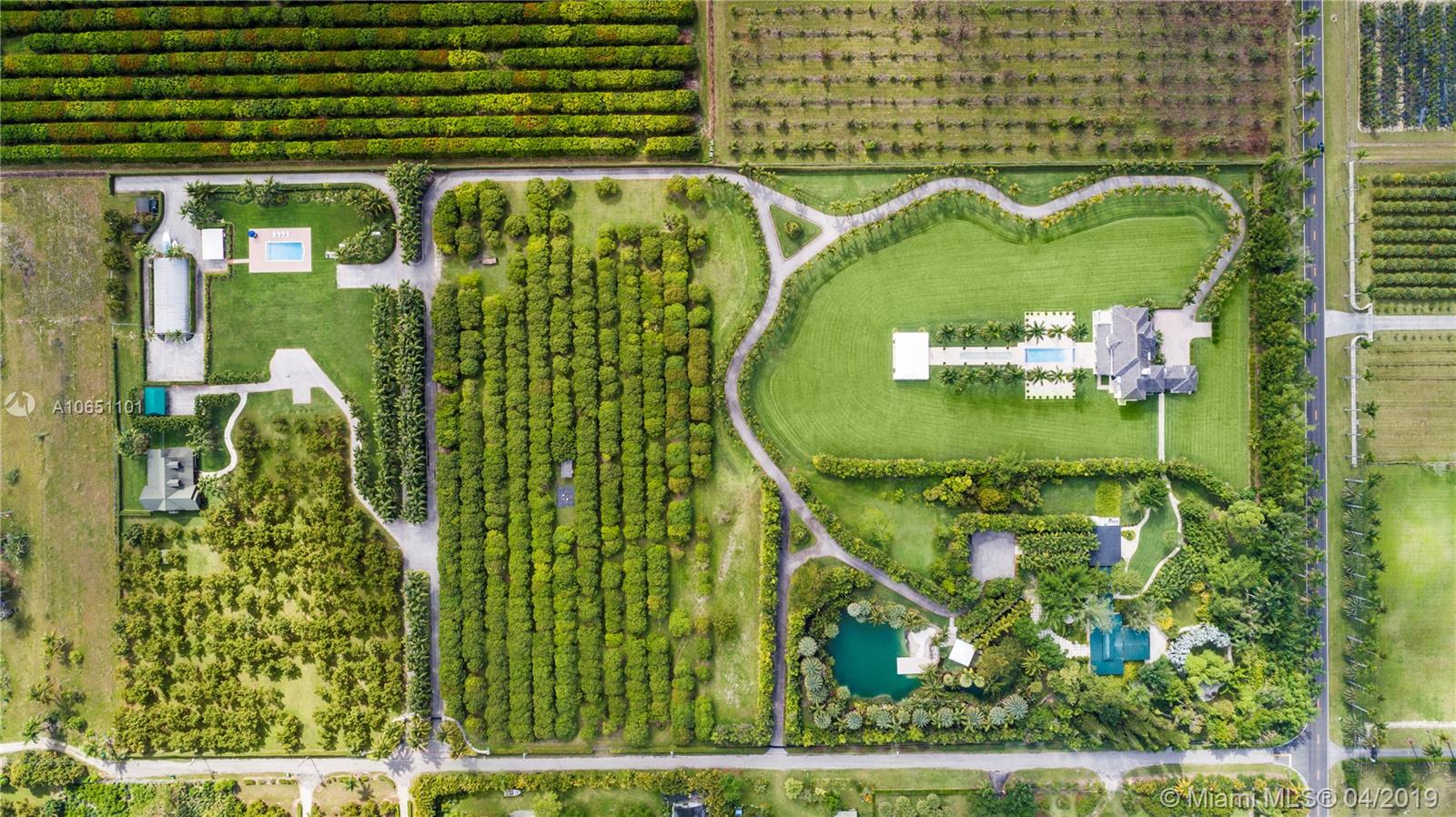 Welcome to Paradise! Magnificent 20 Builder’s-Acre Estate located in the Redland.  This impressive compound estate consists of two homes, entertainment pavilion, 20-car hangar, and agriculture parcels. *Main house is 6 Bed/5 Bath & 2 car garage, with breathtaking backyard overlooking infinity pool, fountain and gazebo *Guest house is a 3 bed/2 bath with its own private pool, *Entertainment pavilion has full kitchen, 2 bathrooms and a pathway leading to 2,523 SF covered screened patio.  Air conditioned customized car hangar which can accommodate up to 20 cars. Agricultural acreage with fruit trees, resort style fresh water beach lagoon with cascading waterfalls, manicured landscaping & gardens make this property a Paradise Found.