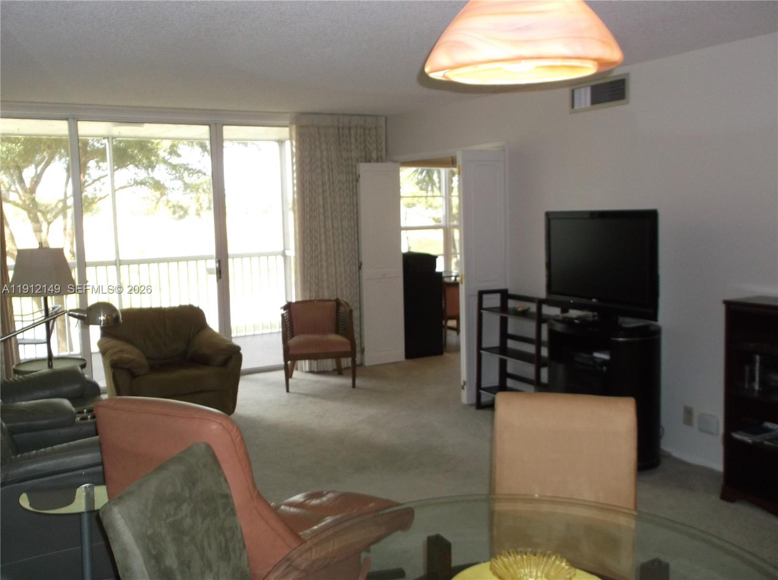 Great 2/2 in sought after Palm Aire North! Well-maintained building with expansive views and large set-backs offer relaxing vistas in a serene oasis. This home is meticulously kept, new neutral carpeting. Windows are impact. Building offers clubhouse, choice of pools, outdoor facilities for BBQ and more.   From your living room and porch, be entertained by wildlife feeding near the water and enjoy miles of walking trails around the lakes. This well-established community is conveniently located near shopping and services and will enjoy the completion of "The Pomp", an upscale entertainment complex nearby. Furniture may be included for a turn-key experience.