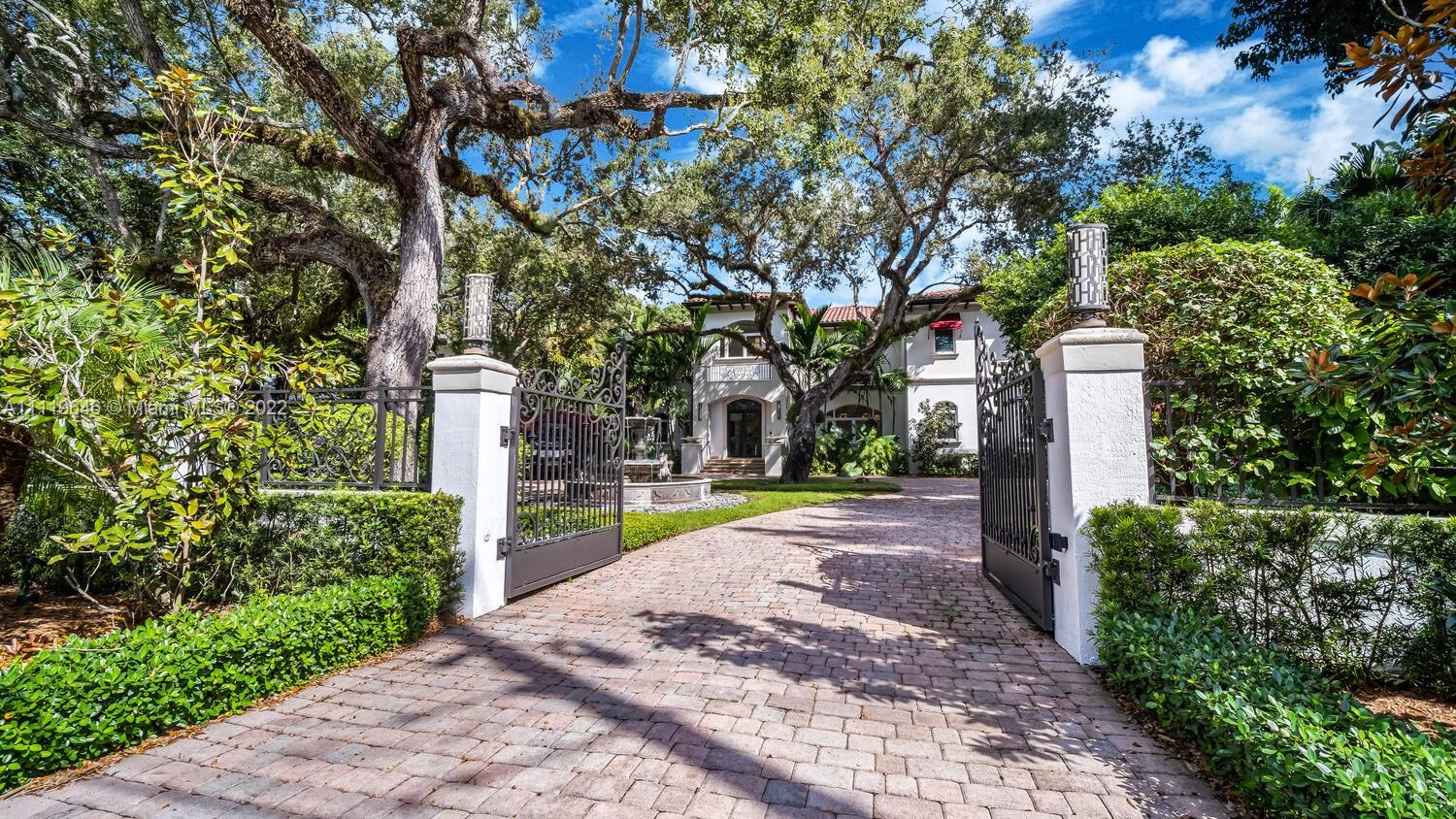 Beautifully appointed Ponce Davis Modern Mediterranean Estate! Spacious Foyer welcomes you to the home’s stately grandeur. It's sweeping circular staircase ushers you to the second floor. Grand Main Bedroom has wood floors, wet bar, his & hers closets, balcony overlooking pool and garden, main bathroom featuring dual water closets, glass shower, luxurious circular tub, four additional en-suite bedrooms, one converted to home theater, upstairs gym, double sided indoor waterfall, formal living, dining, breakfast nook, Modern Chef’s Kitchen, family room, solarium game room. Outdoors features heated pool, spa, summer kitchen, fire pit & lovely garden. Furniture and gym equipment available for purchase. As per plans, house is 8,377 SF. MAKE AN OFFER.