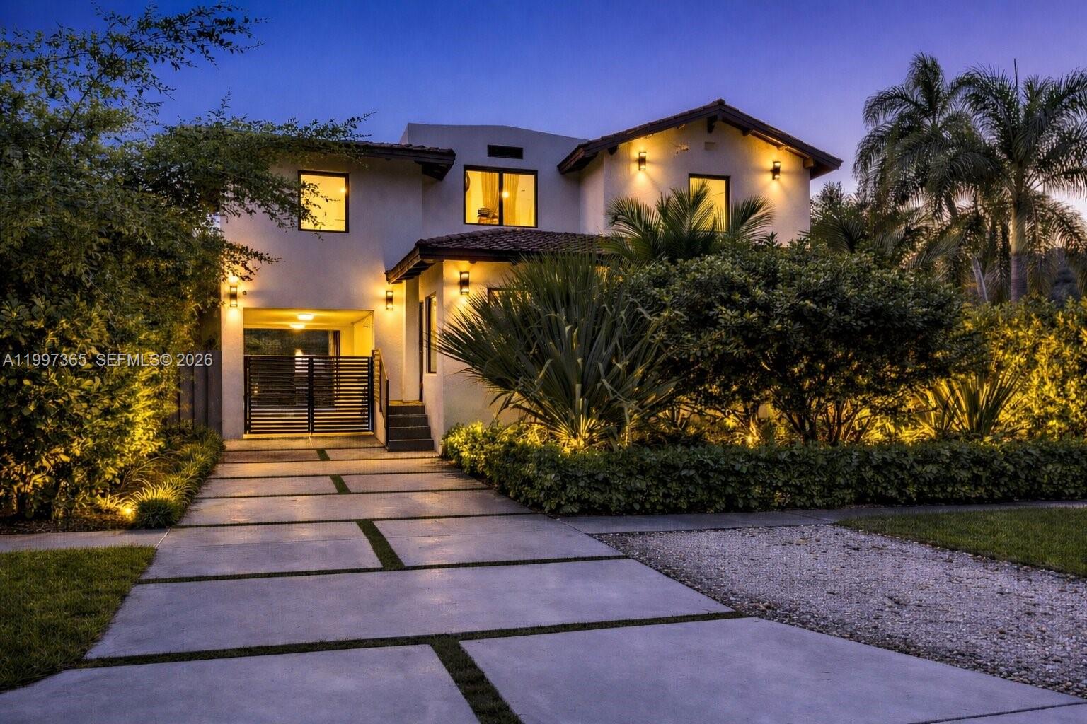A masterfully reimagined Spanish Mediterranean compound where timeless architecture meets bespoke modern design. Set within a private, lushly landscaped setting, the property offers nearly 3,000 SF of living space, including a 4-bedroom, 3-bath main home and a detached two-story guest house with 569 SF of living area.
The main level, redesigned by Miami-based MONIOMI Design, features custom millwork, curated finishes, and bright open living spaces ideal for everyday living and entertaining. A built-in dining banquette anchors the space, flowing into a chef’s kitchen with an oversized island and professional-grade Thermador appliances.
Upstairs, the private quarters continue with elevated finishes and premium fixtures throughout, including Toto toilets. The detached guest house includes its own kitchen, living area, full bath, and private upstairs bedroom—ideal for guests or a home office. Outdoors, mature tropical landscaping surrounds a sleek pool and spa, creating a private, resort-style setting with fully gated grounds. Located on a quiet tree-lined street in El Portal, the home offers privacy and convenience just minutes from Miami Shores, the Design District, Wynwood, and the beaches.
Designer furnishings are available for purchase, offering a turnkey option if desired.
